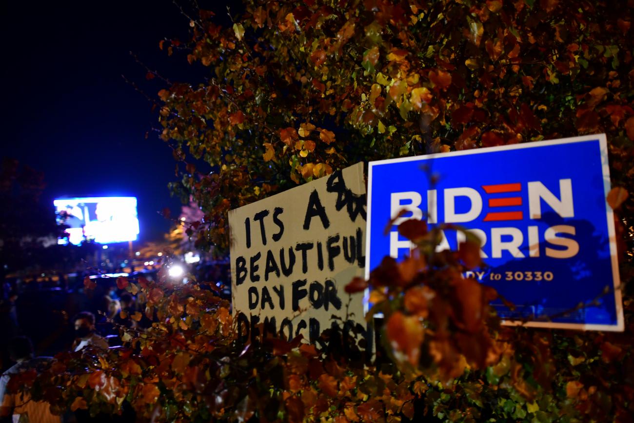 A sign reads "It's a beautiful day for democracy,