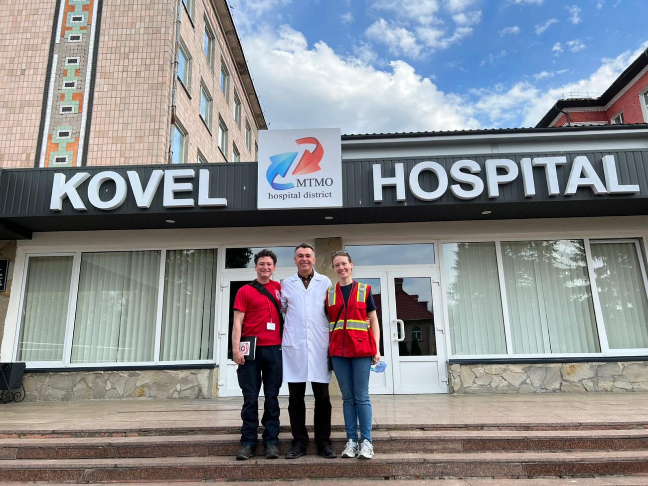 CMAT's David Thanh (left), a search-and-rescue and mobile clinic specialist, and Sarah Scott (right), an emergency physician, with a local doctor at Kovel Hospital in western Ukraine, March 2022.