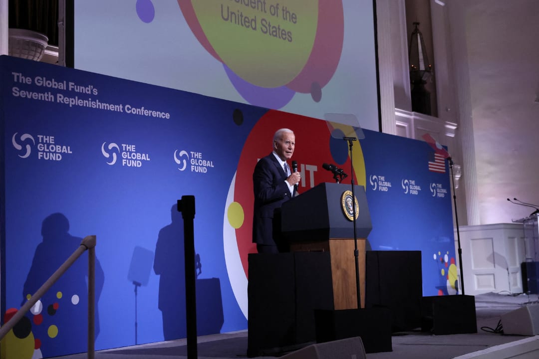 U.S. President Joe Biden stands on a stage in suit and tie and delivers remarks at the Global Fund's Seventh Replenishment Conference in New York, on September 21, 2022. REUTERS/Leah Millis