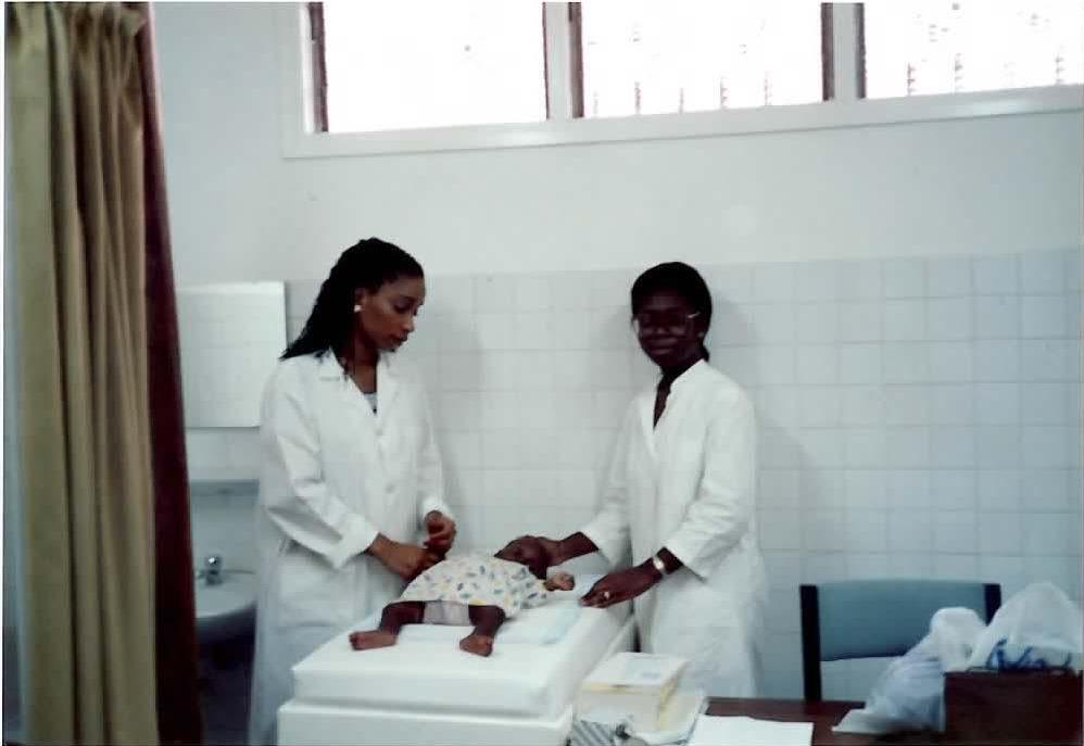 Dr, Helene Gayle and a colleague are seen tending to an infant, at a hospital in Abidjan, Cote d'Ivoire, in 1990.