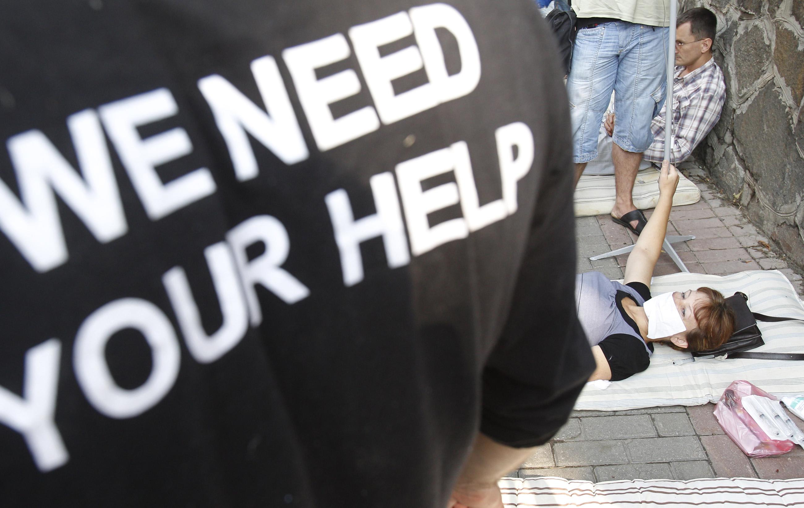 Activists, doctors and some HIV-infected patients protest against the enforced relocation of Kiev's Infectious Diseases Hospital in front of the cabinet ministers building in Kiev July 7, 2010.