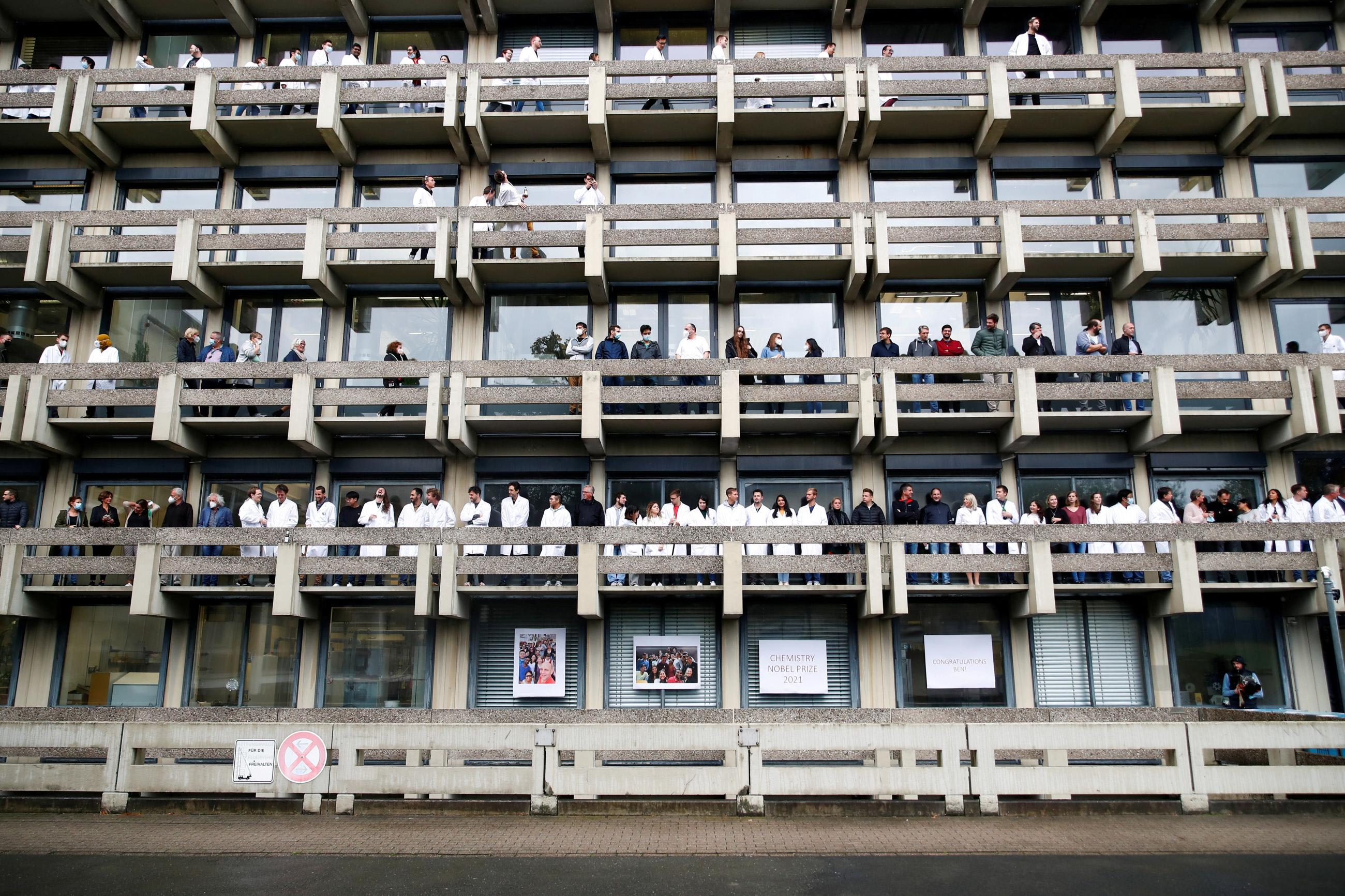People wait for scientist Benjamin List, co-winner of the 2021 Nobel Prize in Chemistry, to arrive at the Max-Planck-Institute for Coal Research, in Muelheim an der Ruhr, Germany, on October 6, 2021.