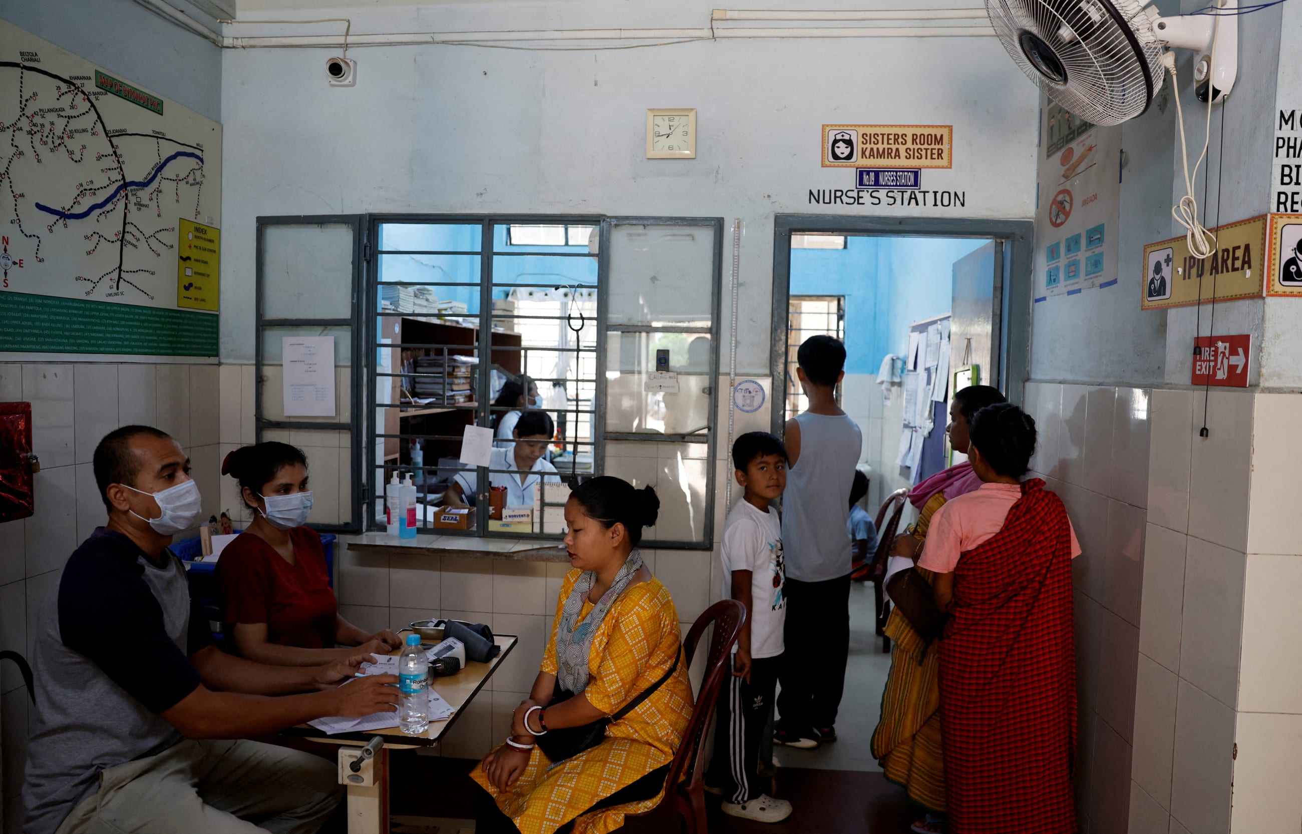 Health workers process patients for consultation inside a primary health-care center, Byrnihat, in India, on March 28, 2025.