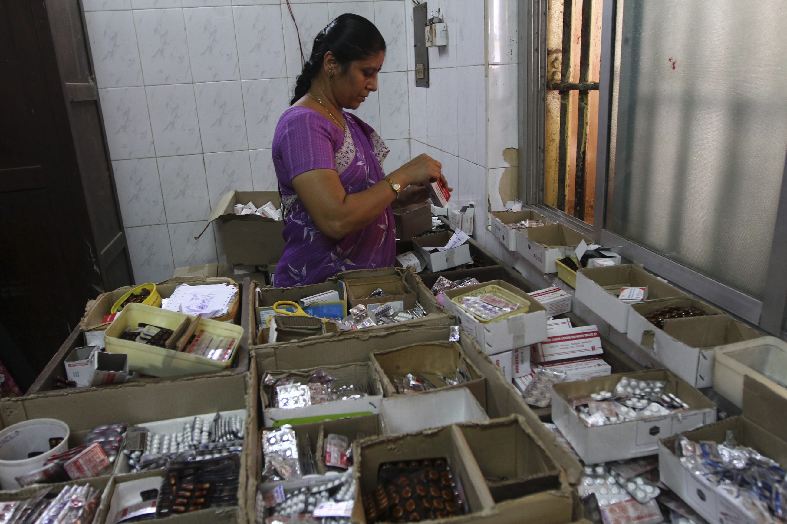A pharmacists sorts free medication provided by the government, which will be given to patients, at Rajiv Gandhi Government General Hospital, in Chennai, India, on July 12, 2012.