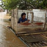 After a period of intense flooding, a man uses a floating public toilet on the Ciliwung river bank in Jakarta, Indonesia, on December 28, 2006.