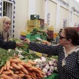 A woman buys vegetables from a vendor on the first day of Ramadan, the Muslim holy fasting month, in a market downtown in Tunis,Tunisia, on June 18, 2015.