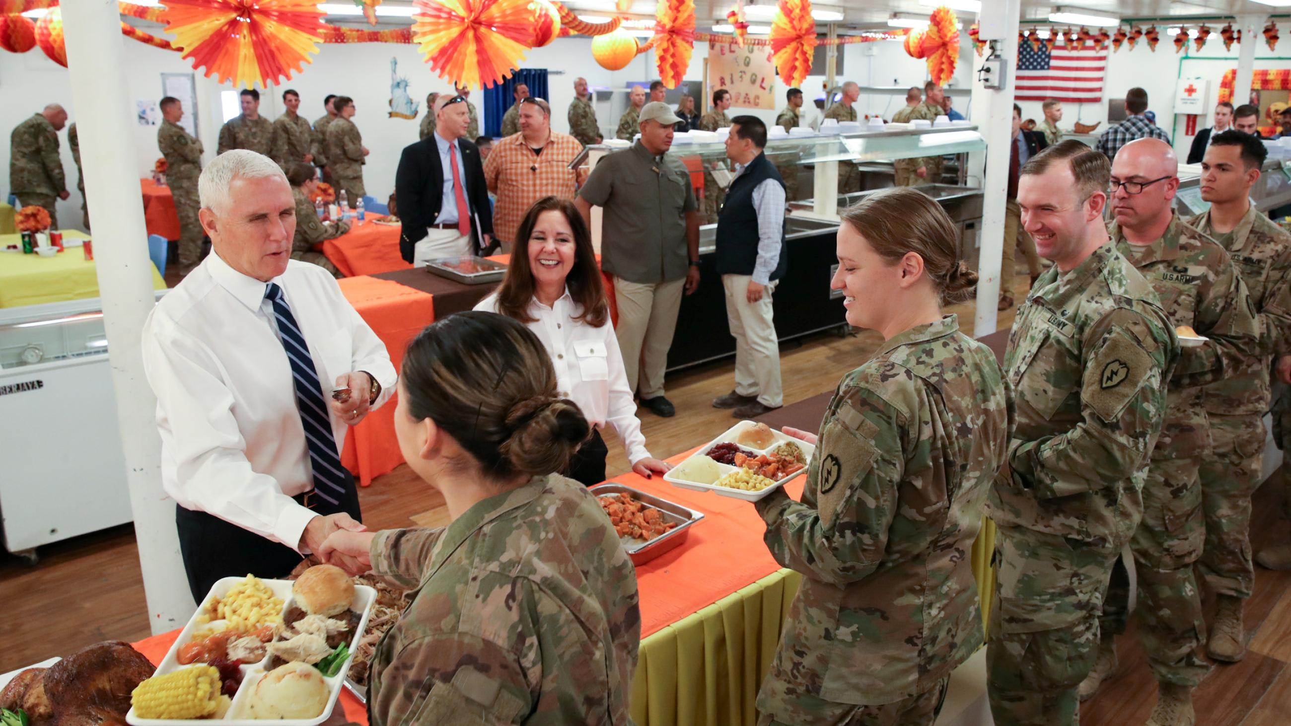 U.S. Vice President Mike Pence and his wife Karen Pence helped serve a Thanksgiving meal to U.S. troops in a dining facility at Camp Flores on Al Asad Air Base, in Iraq, on November 23, 2019.