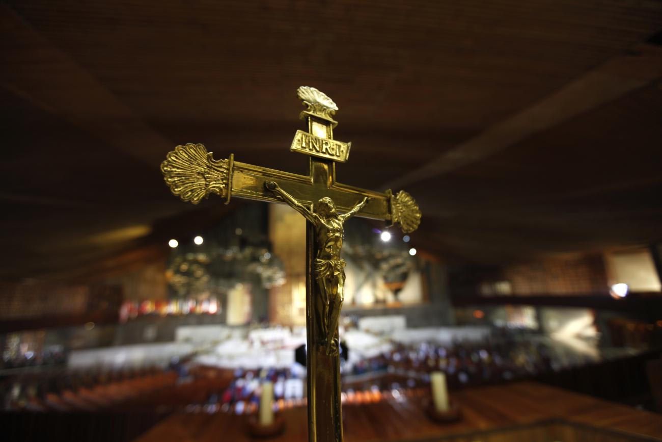 A golden crucifix stands inside the Basilica de Guadalupe in Mexico City.