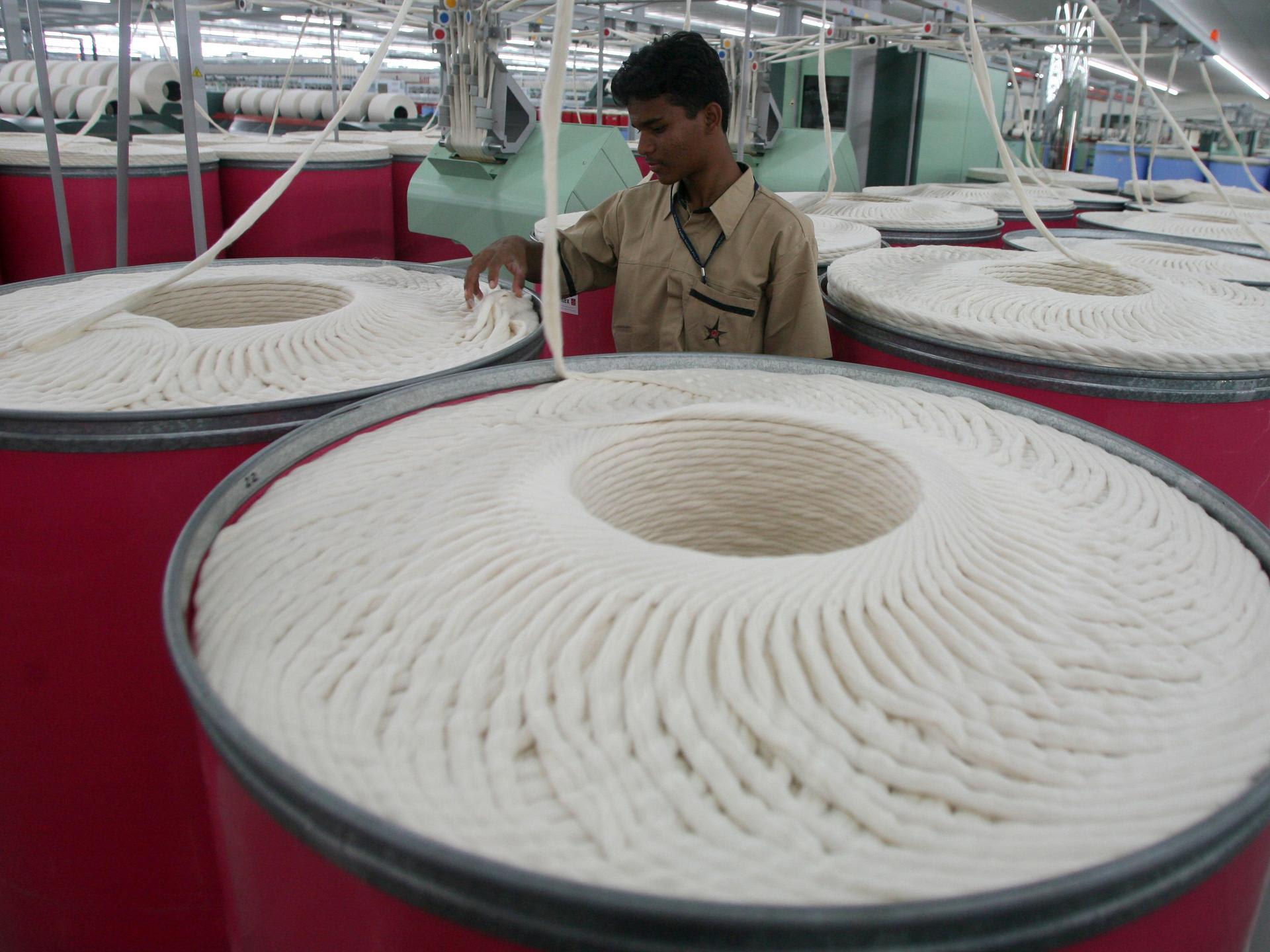 An employee works inside the Century Textiles and Industries Ltd. textile mill, in Gujarat, India, on October 22, 2009.