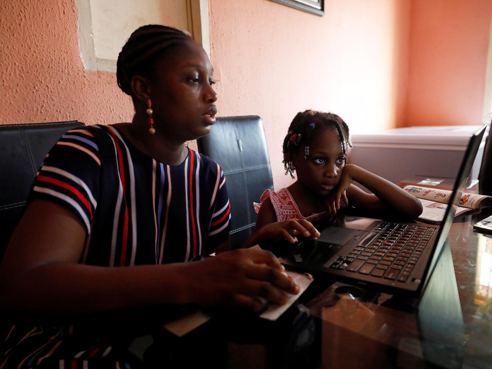 Kesieana Onoge and her daughter Naomi Onoge, 6, struggle to navigate the online learning system from their home, in Lagos, Nigeria, on April 23, 2020.