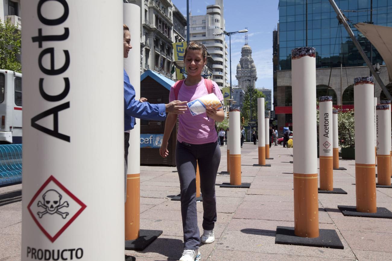 People walk past near an anti-tobacco installation during the Fourth Conference of the Framework Convention on Tobacco Control.