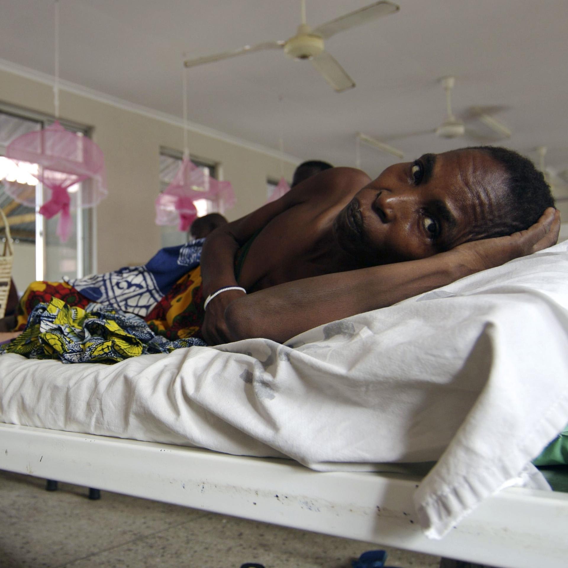 A cervical cancer patient lays on a bed in the female ward of a cancer institute, in Dar es Salaam, Tanzania, on November 11, 2009.