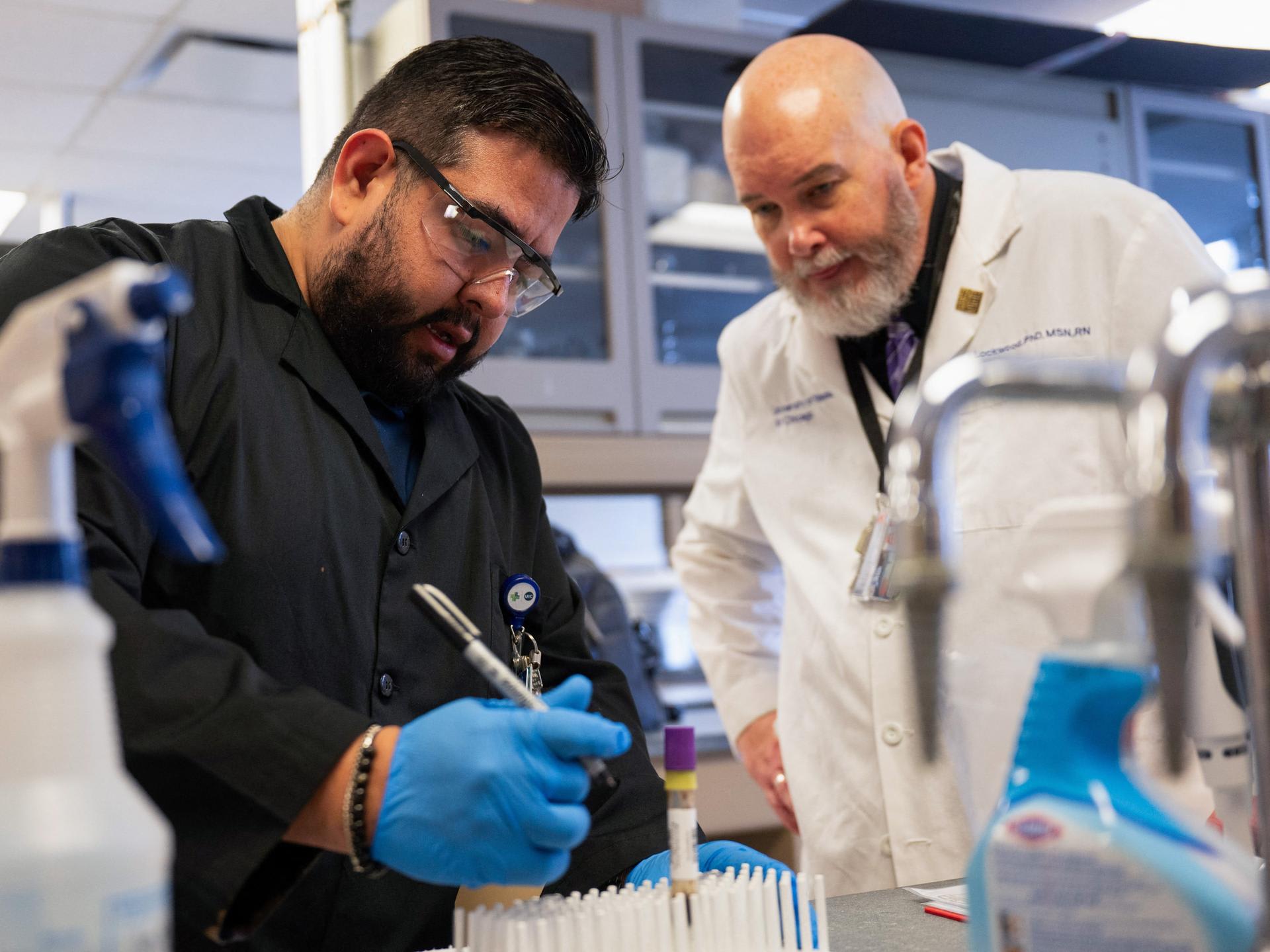 A professor at the University of Illinois Chicago College of Nursing, works with a research specialist, as a part of a study under a RO1 federal grant, in Chicago, Illinois, on February 28, 2025. REUTERS/Vincent Alban