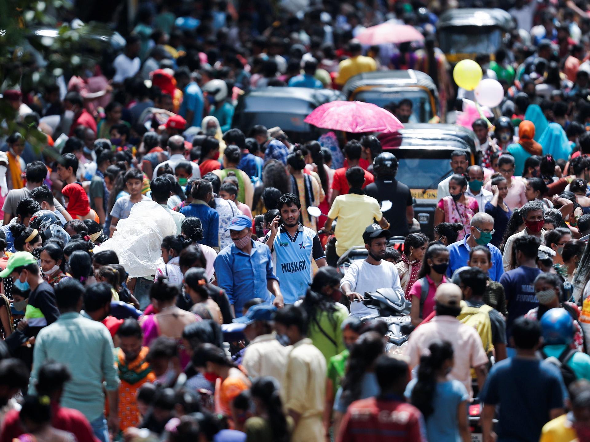 People walk at a crowded market, in Mumbai, India, on August 11, 2021.