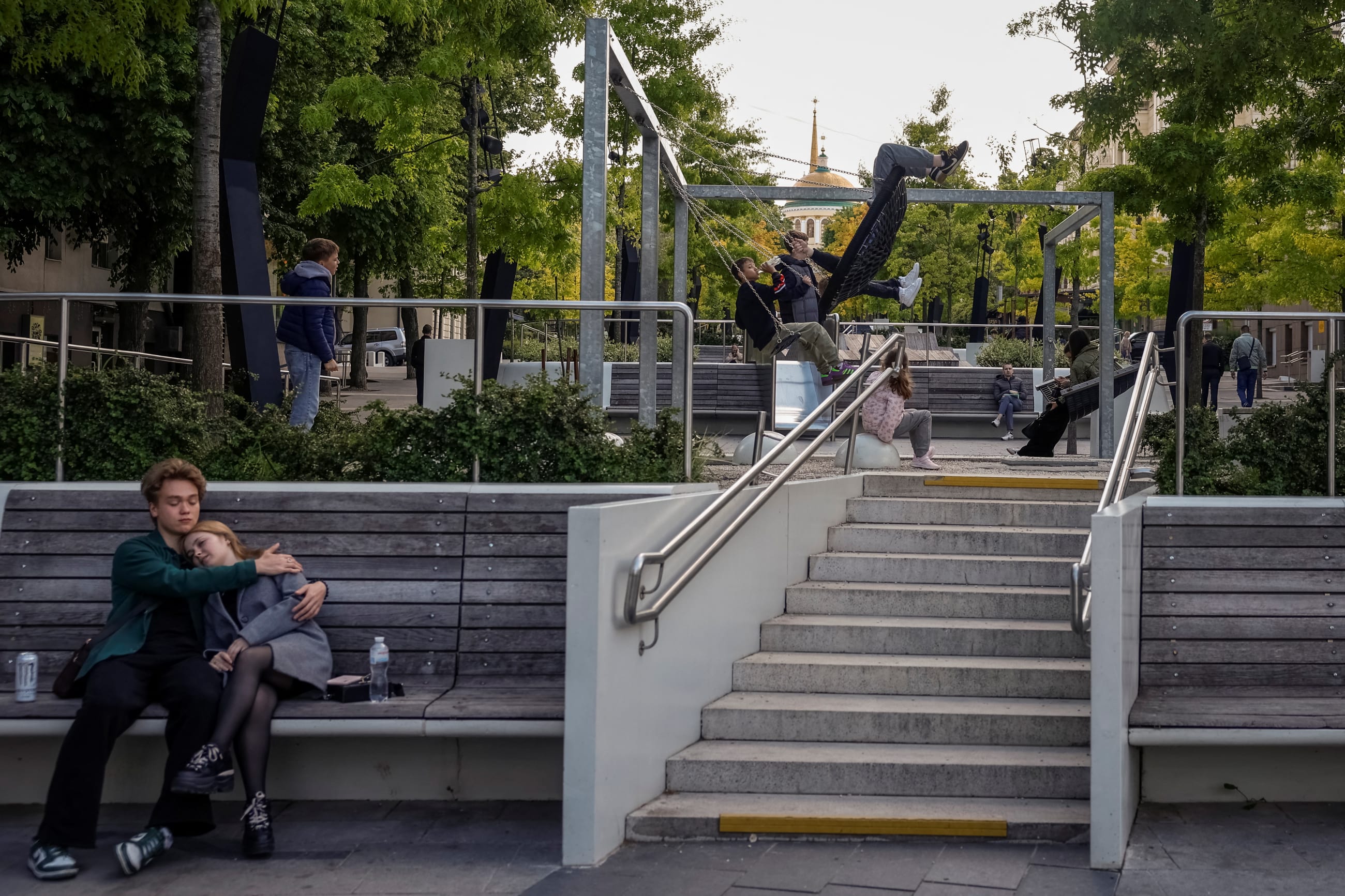 Teenagers rest in a park, amid Russia's attack on Ukraine in Dnipro, Ukraine, on May 13, 2025.