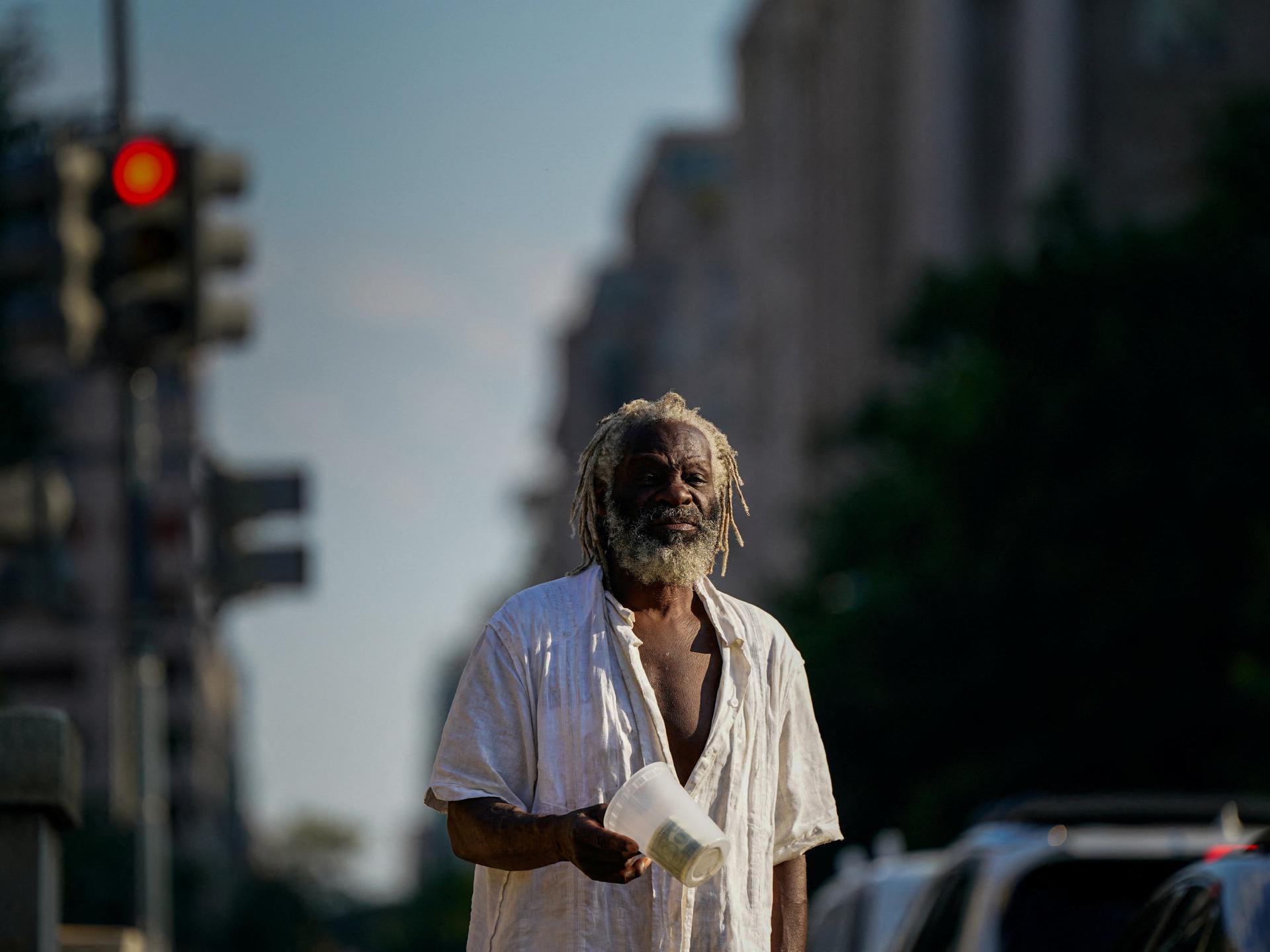 Nathaniel, who is homeless, panhandles near the National Mall after U.S. President Donald Trump federalized the Metropolitan Police Department and deployed National Guard to assist in crime prevention, in Washington, DC, on August 15, 2025.