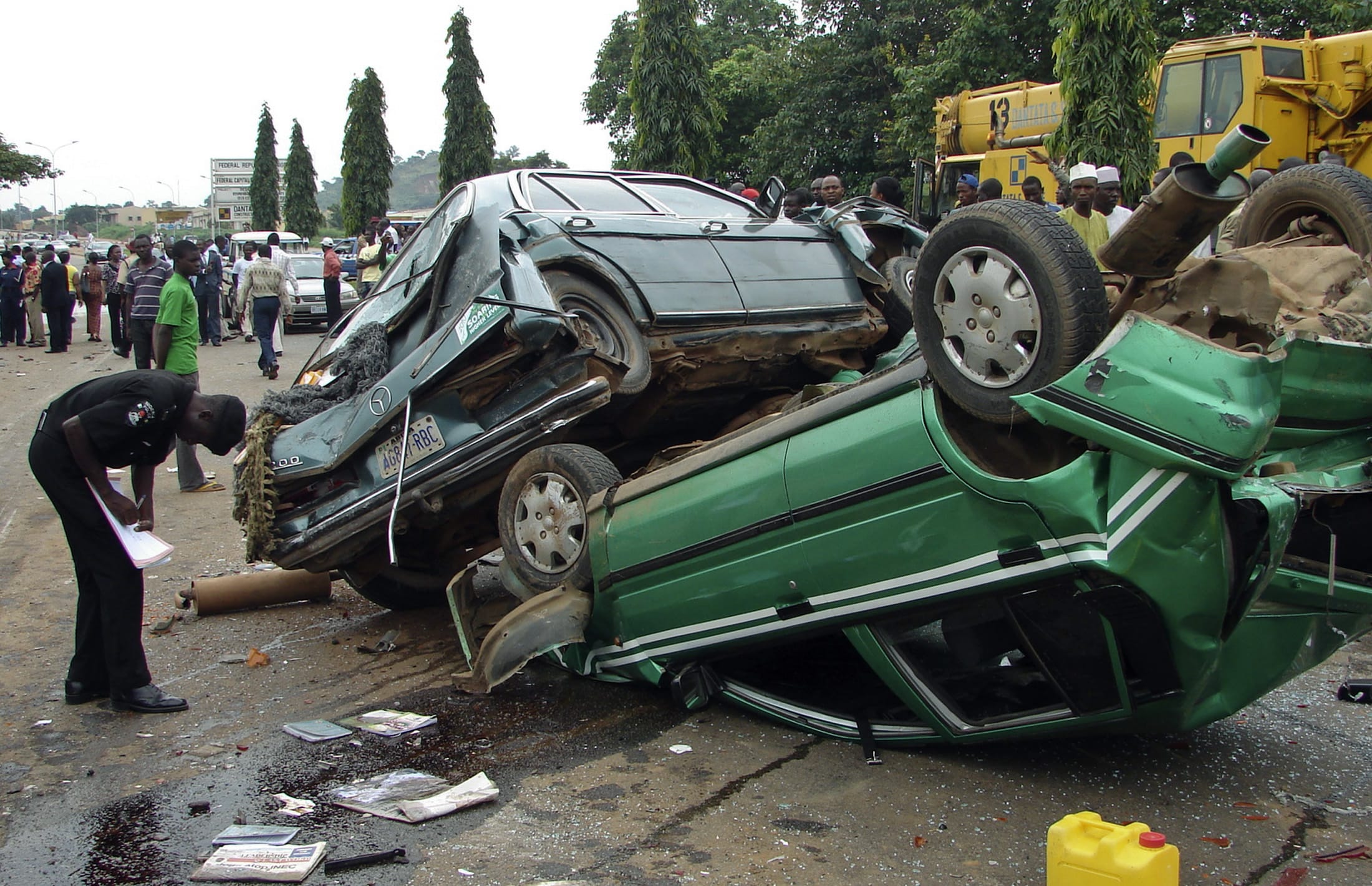 A policemen takes down a record of a multiple road accident, in Asokoro district, Abuja, Nigeria, on August 11, 2010.