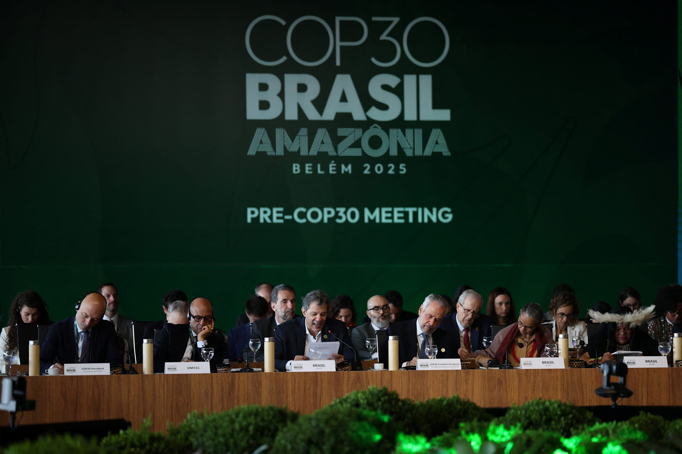 Brazil's Finance Minister Fernando Haddad speaks next to Simon Stiell, Executive Secretary of UN Climate Change (UNFCCC), and Brazil's COP30 President Andre Correa do Lago during the ministerial preparatory meeting ahead of the COP30 Climate Summit, in Brasilia, Brazil, on October 13, 2025.