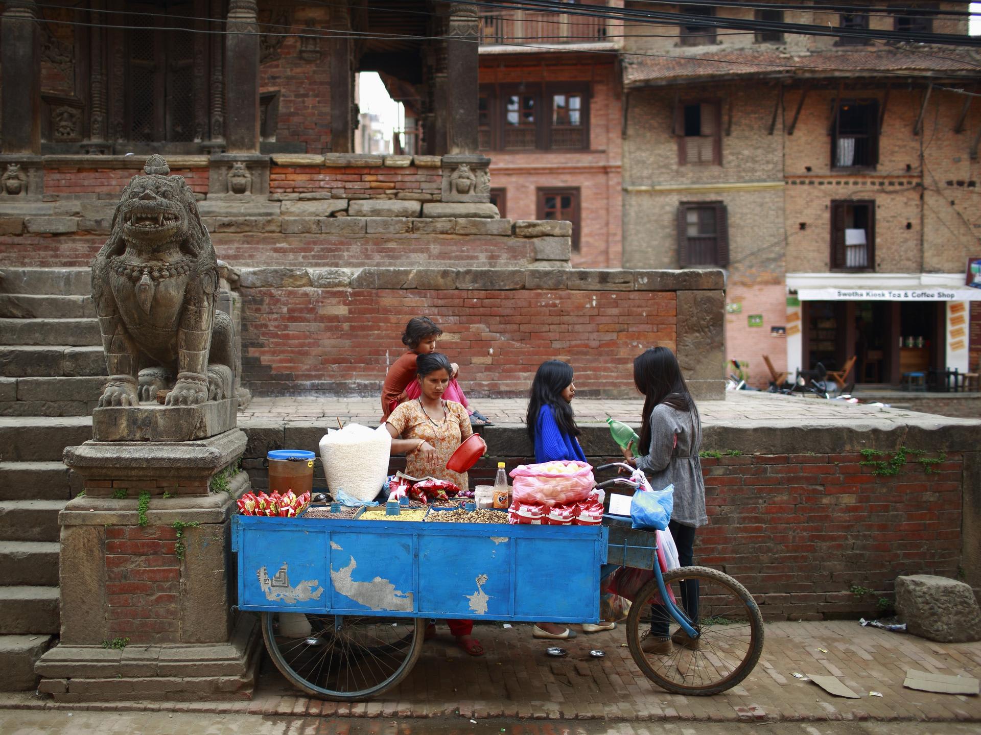 A woman sells beans and snacks at her food stall, in Lalitpur, Nepal, on April 26, 2013.