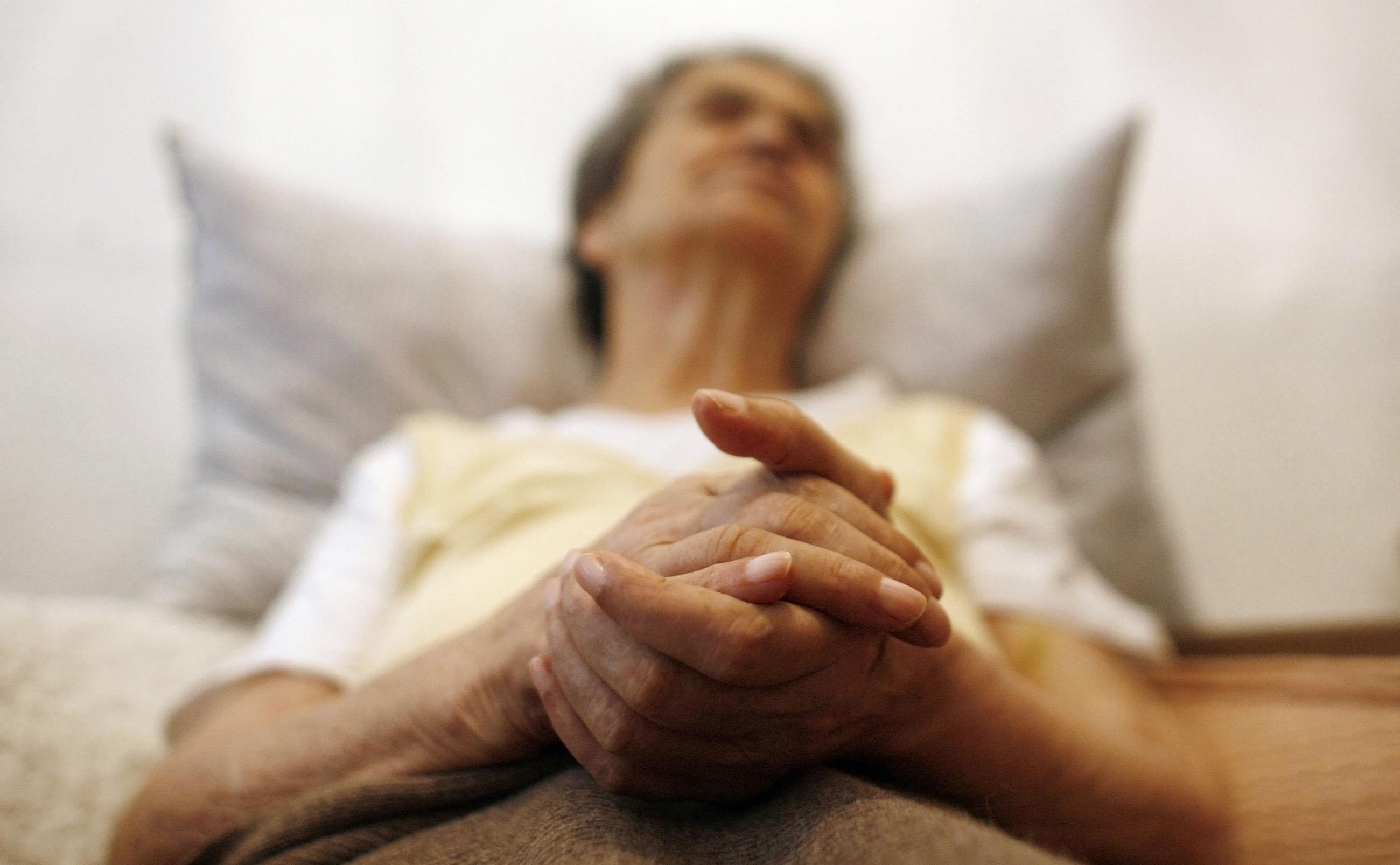 Alzheimer's disease patient Isidora Tomaz sits in an armchair in her house, in Lisbon, Portugal, on September 15, 2009.