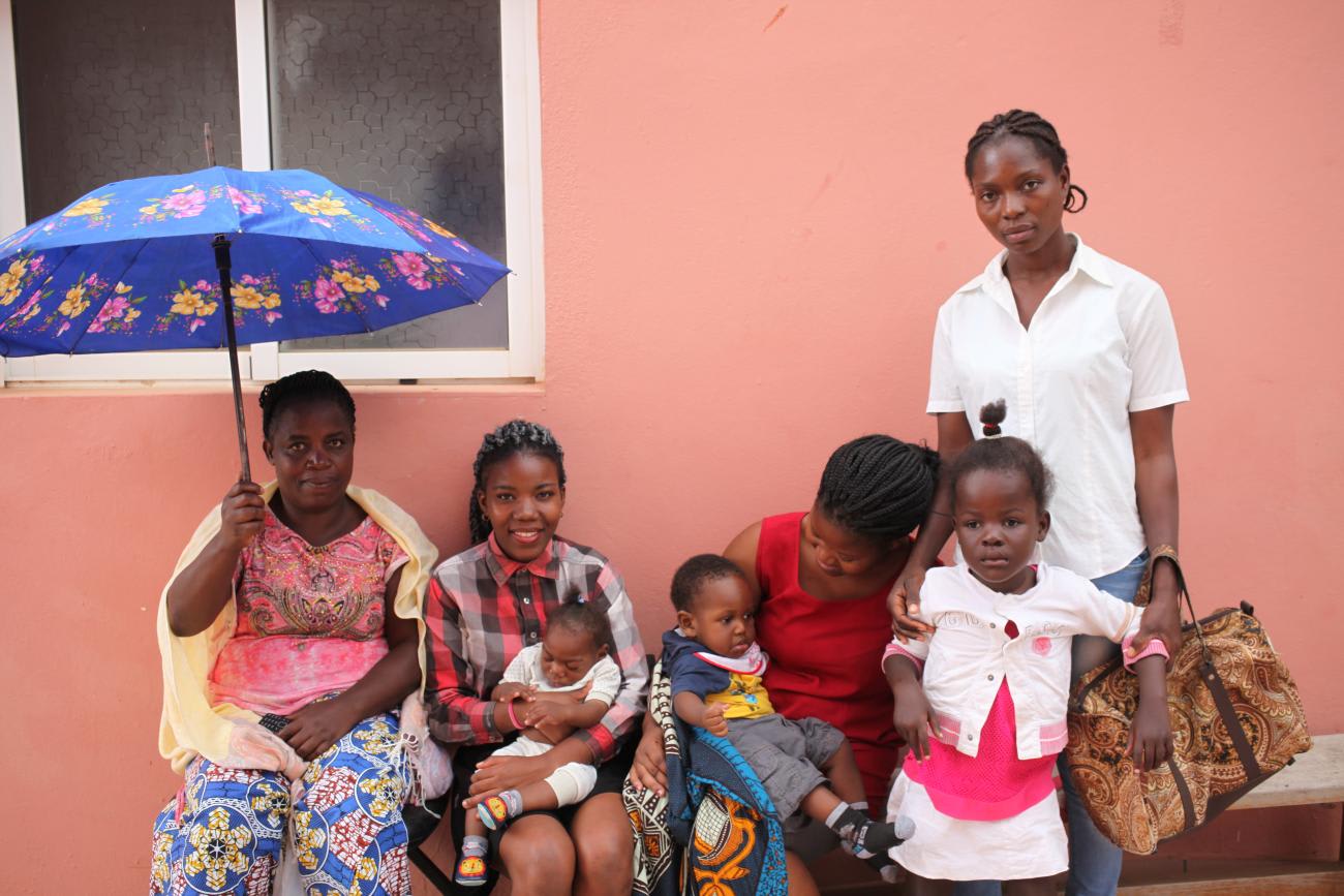 Mothers wait with their children outside the Neurosurgical and Hydrocephalus Treatment Center, in Luanda, Angola, on September 6, 2018.