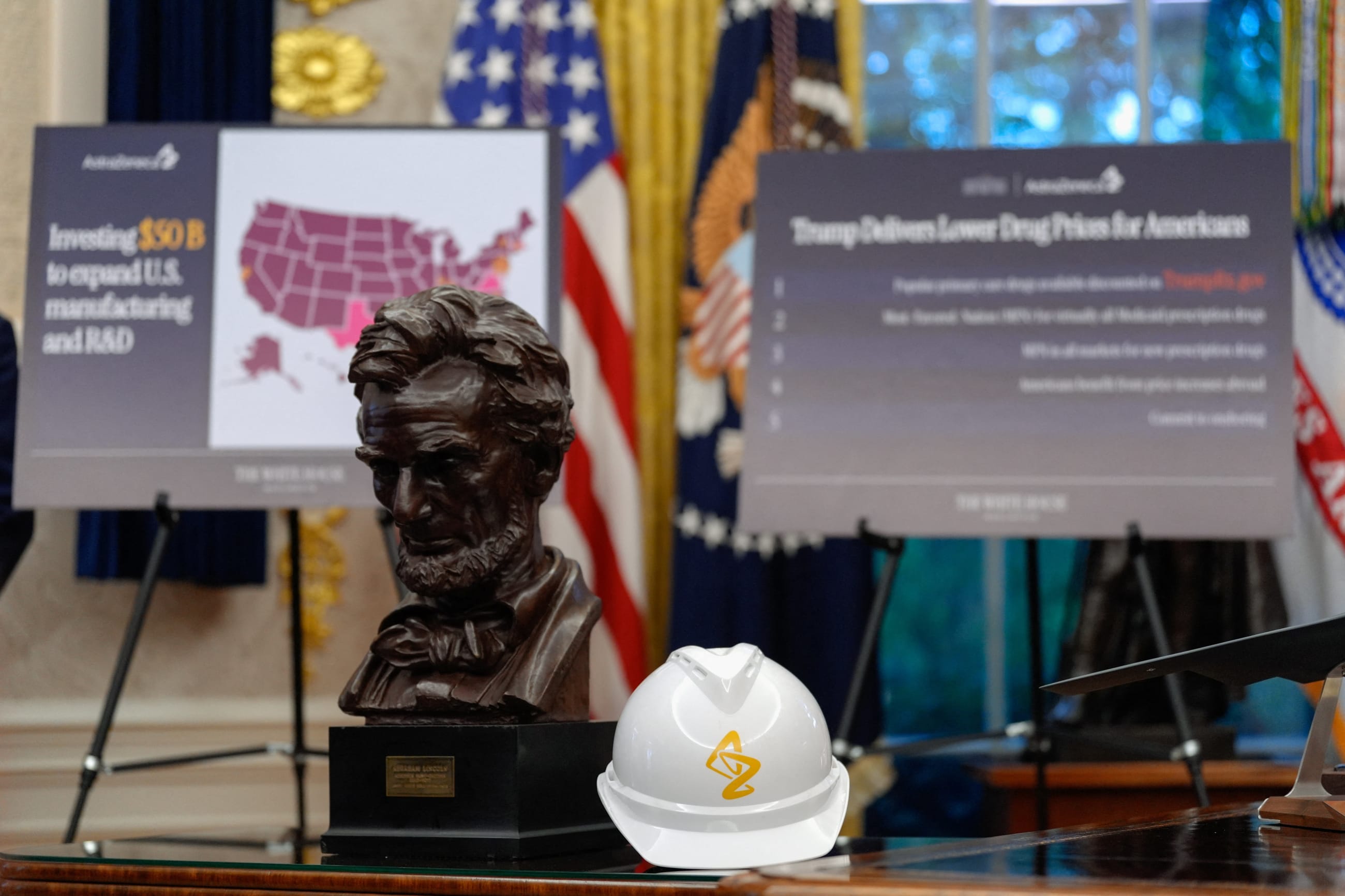 A view of a helmet with the AstraZeneca logo next to a bust of former U.S. President Abraham Lincoln on the day of an announcement about lowering U.S. drug prices, at the White House in Washington, DC, on October 10, 2025.