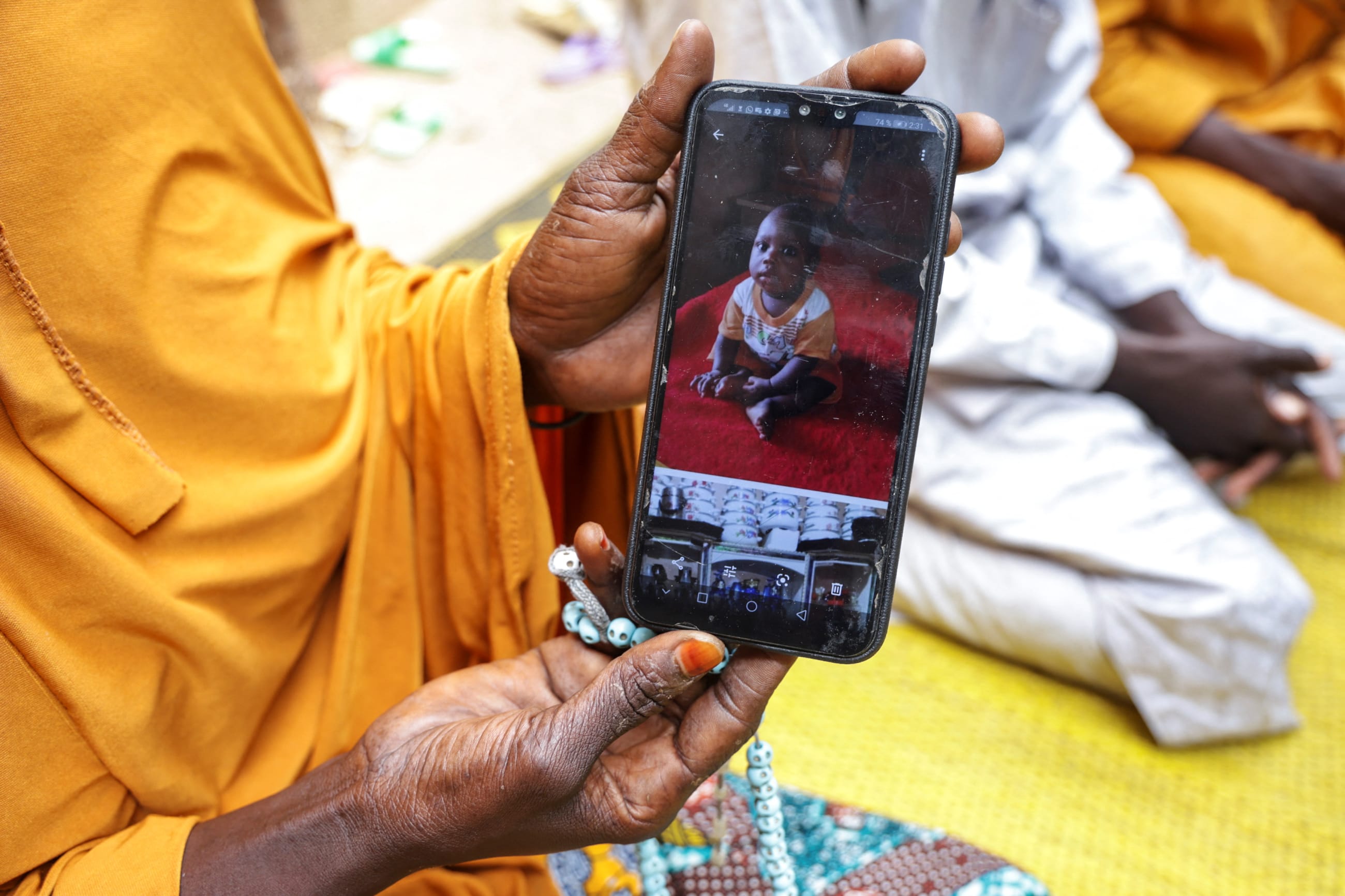 Fatimata Madou, shows a photo of Mohamat, her 9-month old child who died of malaria, in Bogo, Cameroon, on September 4, 2025.