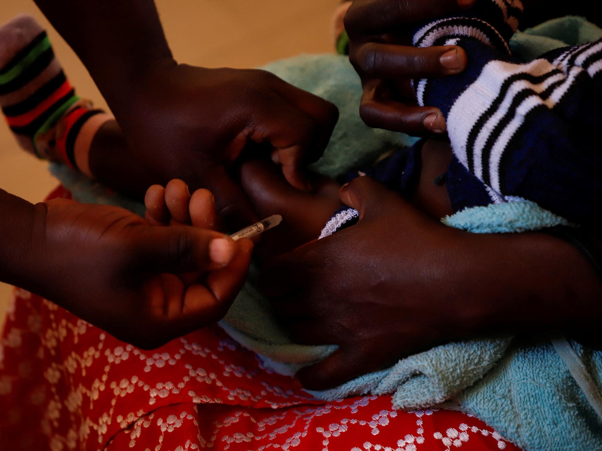 A nurse administers a malaria vaccine to an infant at the health center in Datcheka, Cameroon, on January 22, 2024.