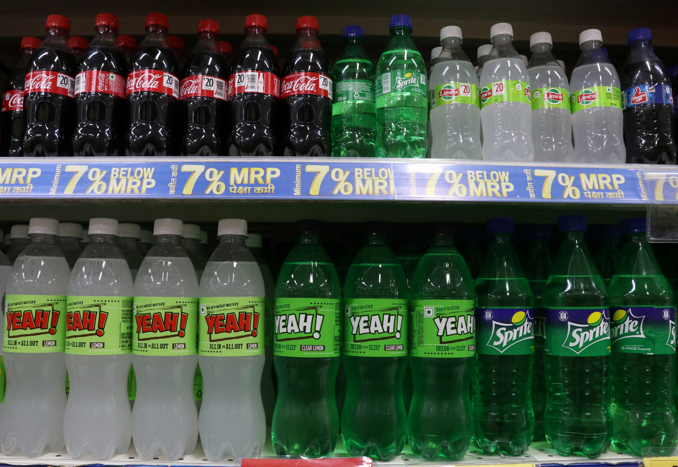 Bottles of Reliance's Yeah! soft drinks sit next to Coca-Cola Co. soft drinks on a shelf inside a Reliance supermarket, in Mumbai, India, on March 16, 2021. Picture taken March 16, 2021.