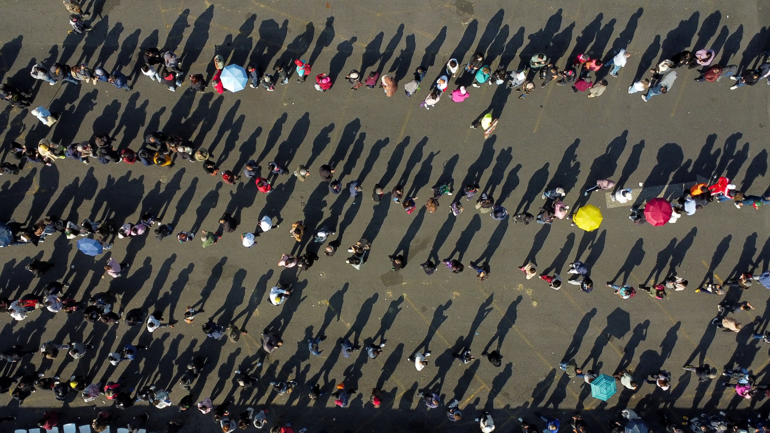 A drone view shows people queuing at a vaccination campaign in response to a measles outbreak, at the Estadio Olimpico Universitario, in Mexico City, Mexico, on November 12, 2025.