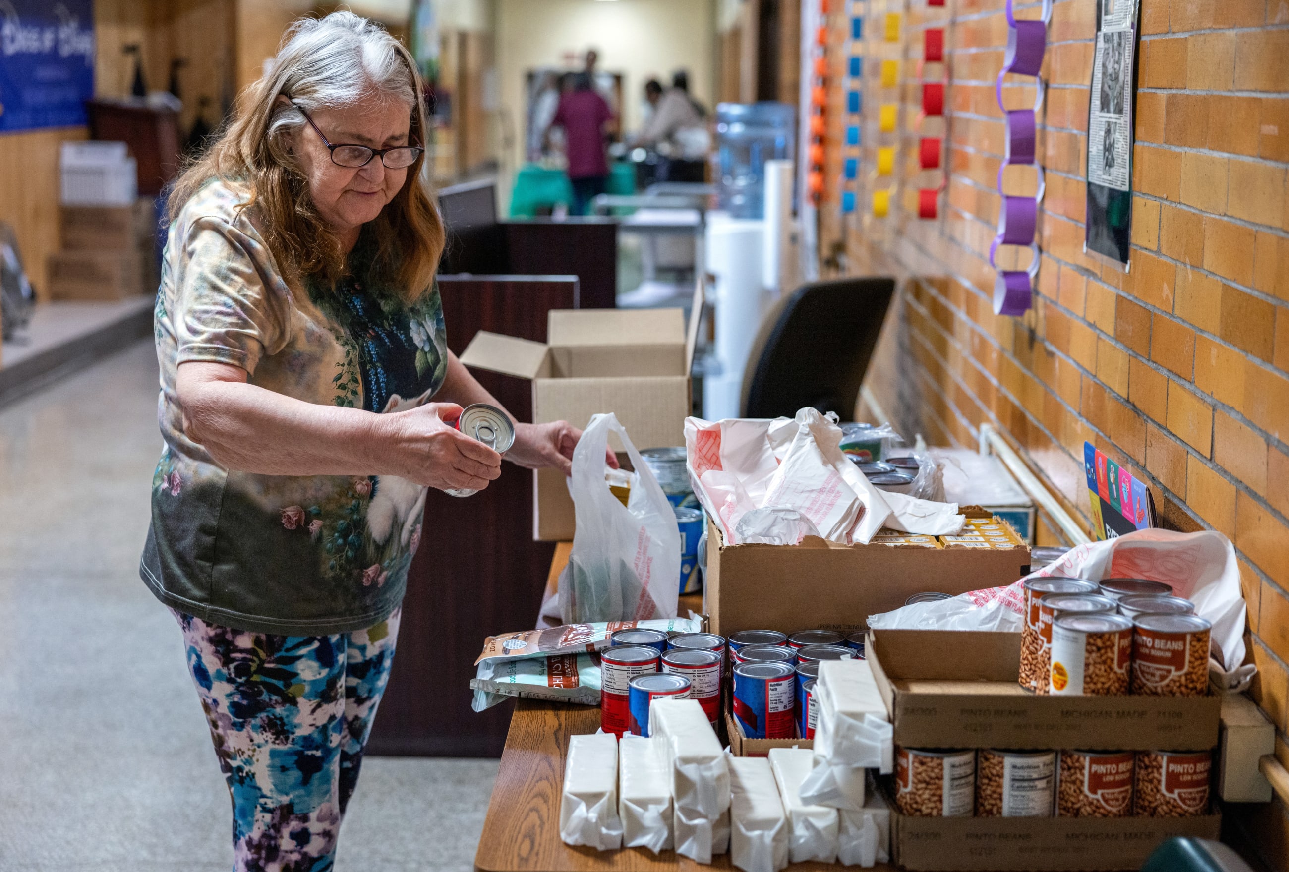 A senior citizen collects food from a pantry supported by Trinity's Table at the Roosevelt Community Center, in Charleston, West Virginia, on March 19, 2025.