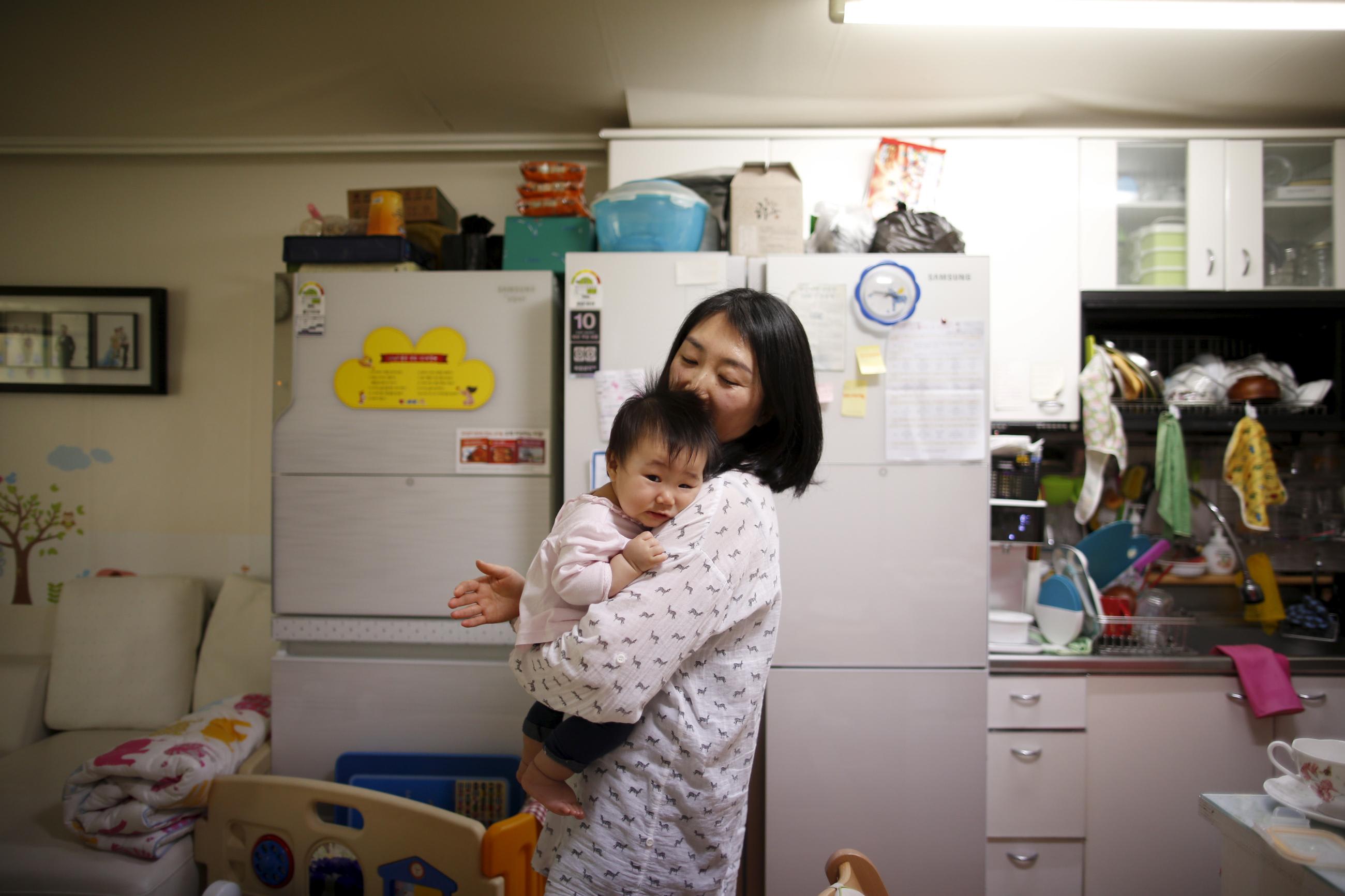 Jeong Bo-mi takes care of her baby at her home.