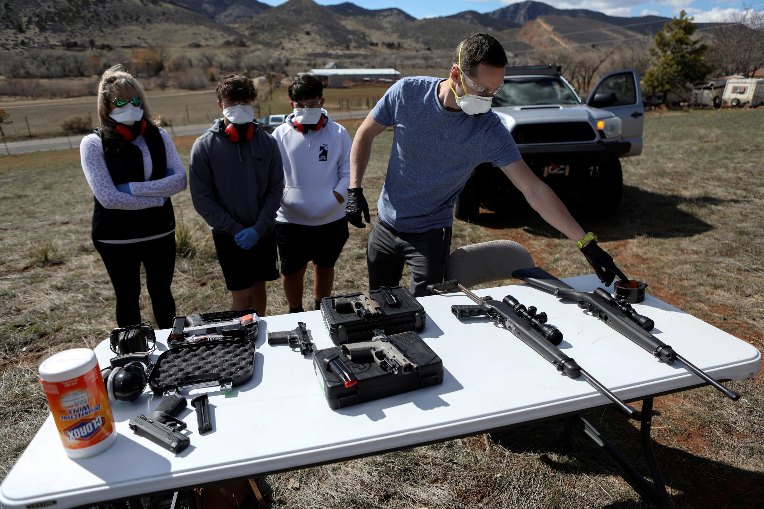 Firearms instructor Joseph Wilkey prepares rifles and handguns during a firearms safety class conducted by Level Up Firearms.