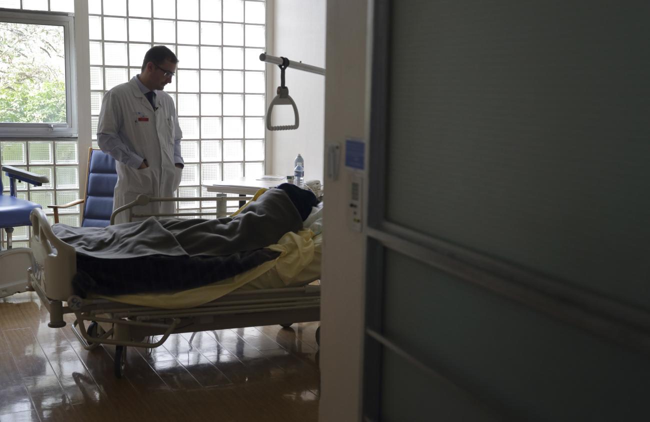 Stephane Mercier, Head of the palliative care unit, visits a patient at the palliative care unit of the AP-HP Paul-Brousse Hospital in Villejuif near Paris March 4, 2015.