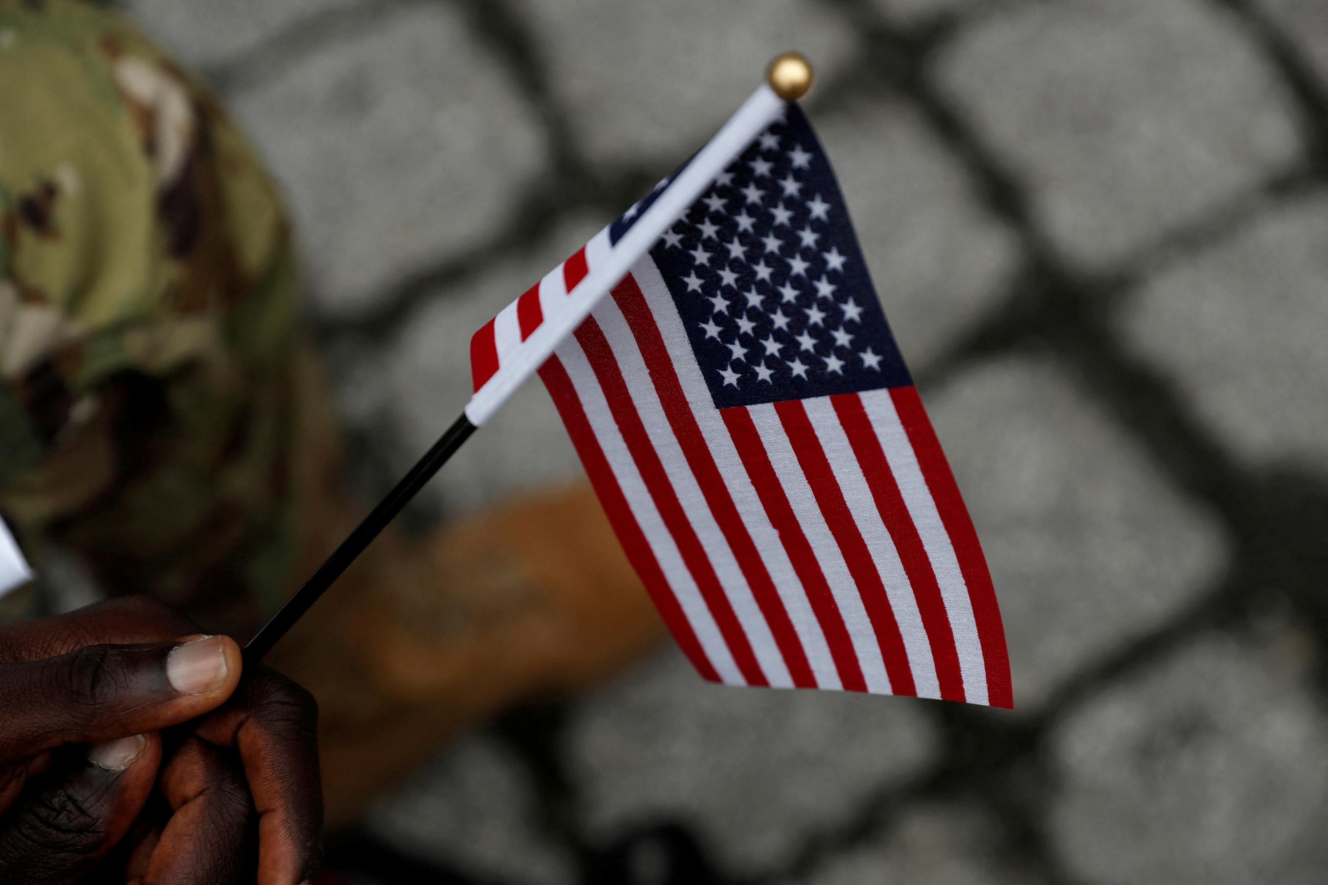 A person holds a U.S. flag during a U.S. Citizenship and Immigration Services naturalization ceremony, in New York City, New York, on September 17, 2021.