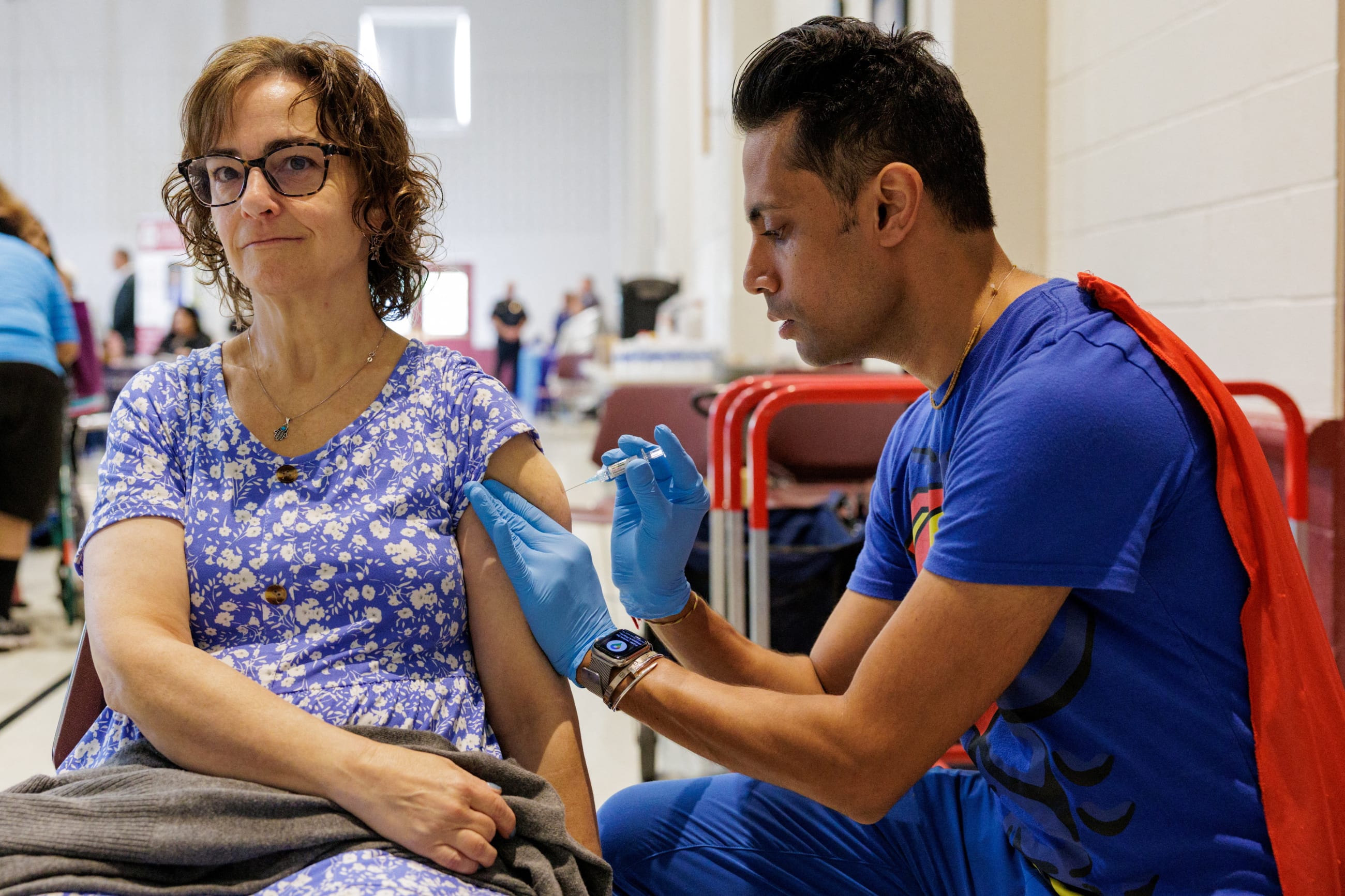 Dr. Mayank Amin administers a dose of a COVID-19 vaccine to Wendy Kaye, 56, as part of Skippack Pharmacy during the Senior Fair at Trinity Lutheran Church in Lansdale, Pennsylvania, on September 4, 2025.