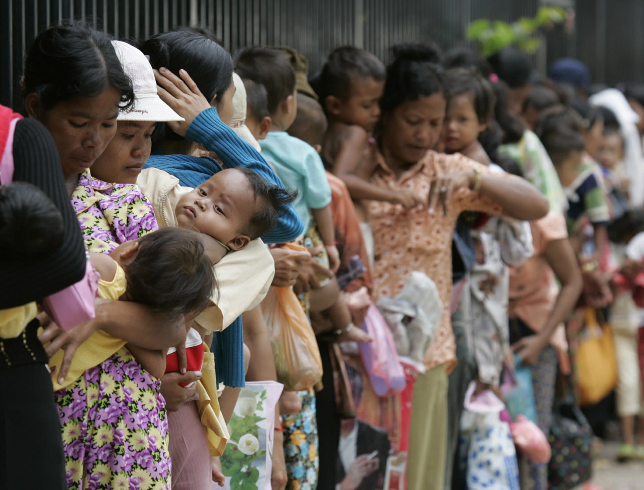 Mothers line-up outside Kantha Bopha VI hospital to seek treatment for their children, in Phnom Penh, Cambodia, on July 3, 2007.