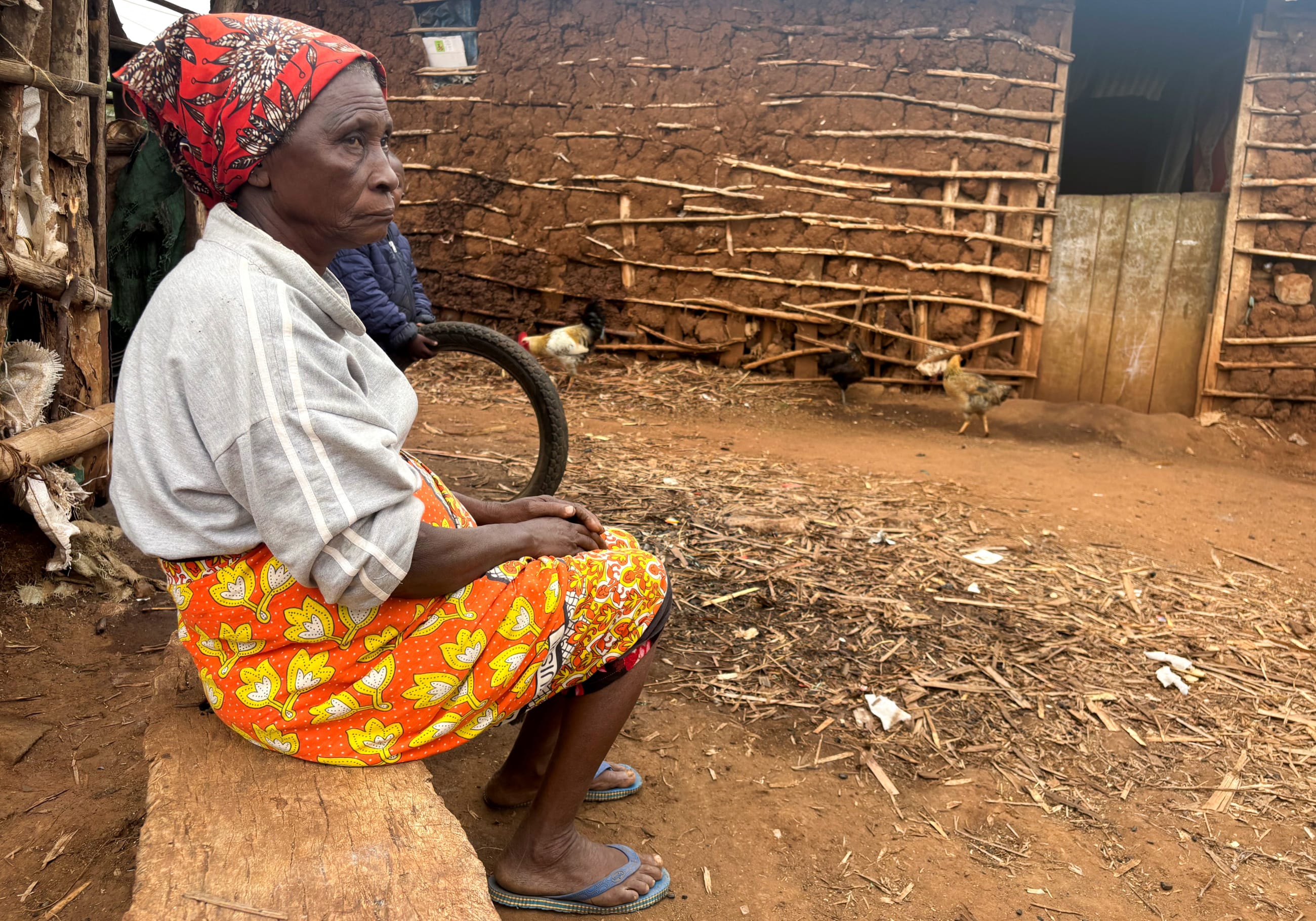 Mary Kibachia, 74, sits outside her mud-patched house before an interview about the impact of sweeping U.S. foreign aid cuts that have left numerous water and sanitation projects incomplete, in Kimorigo village, Taveta county, Kenya, on June 23, 2025.