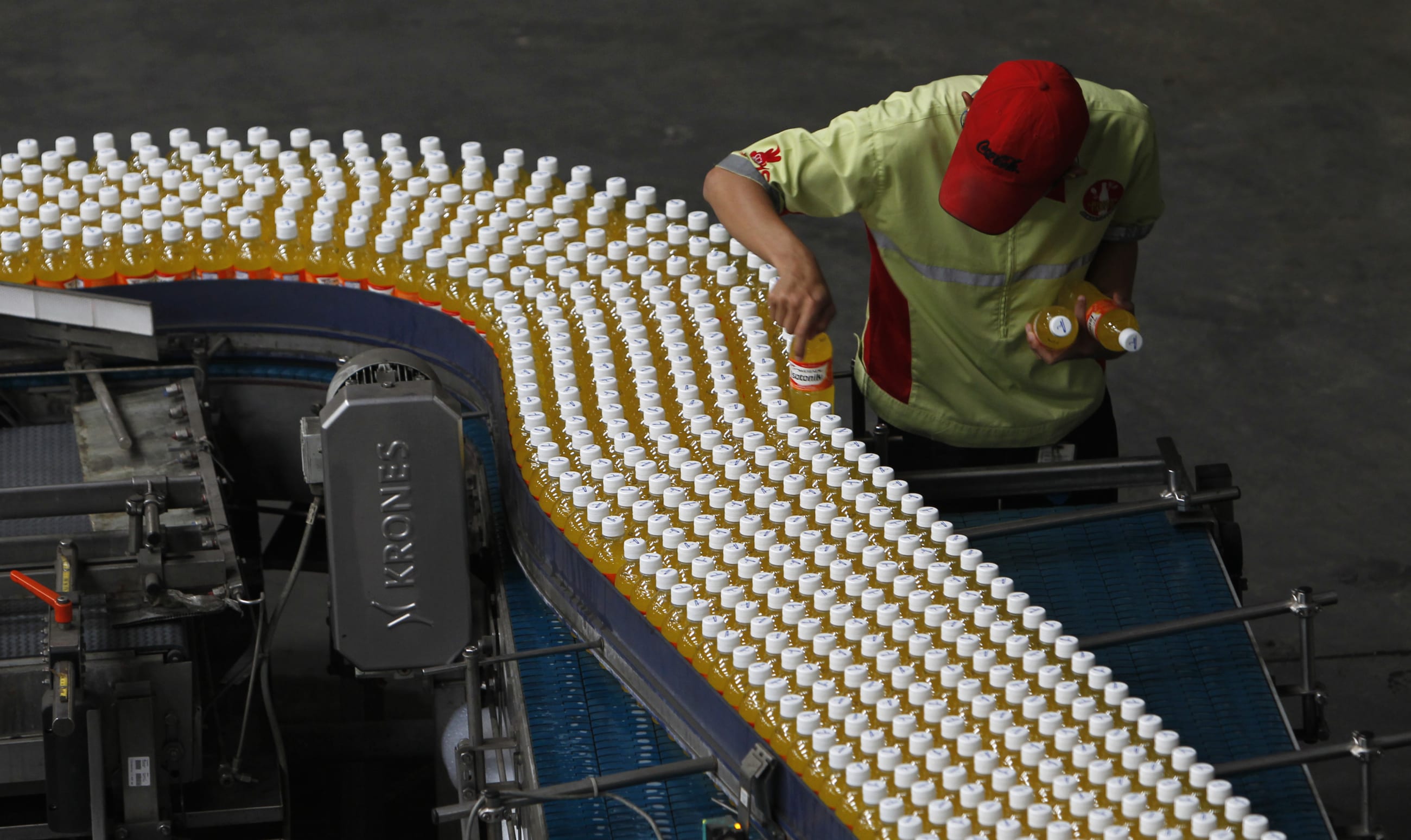 A worker checks drink bottles at PT Coca-Cola Amatil Indonesia's factory in Cibitung, Indonesia, on February 24, 2011.