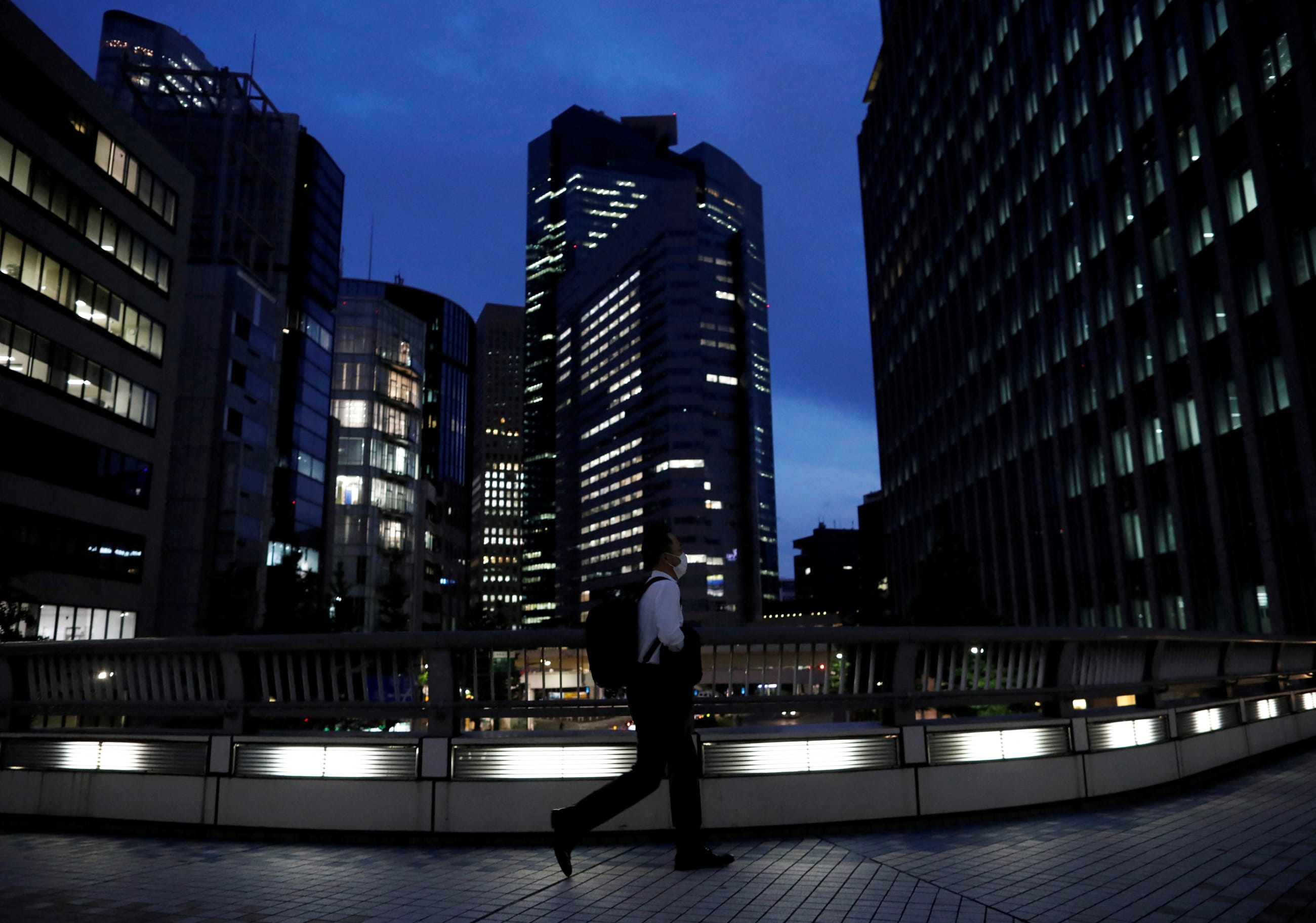 A worker walks past office buildings, in Tokyo, Japan, on June 2, 2020.