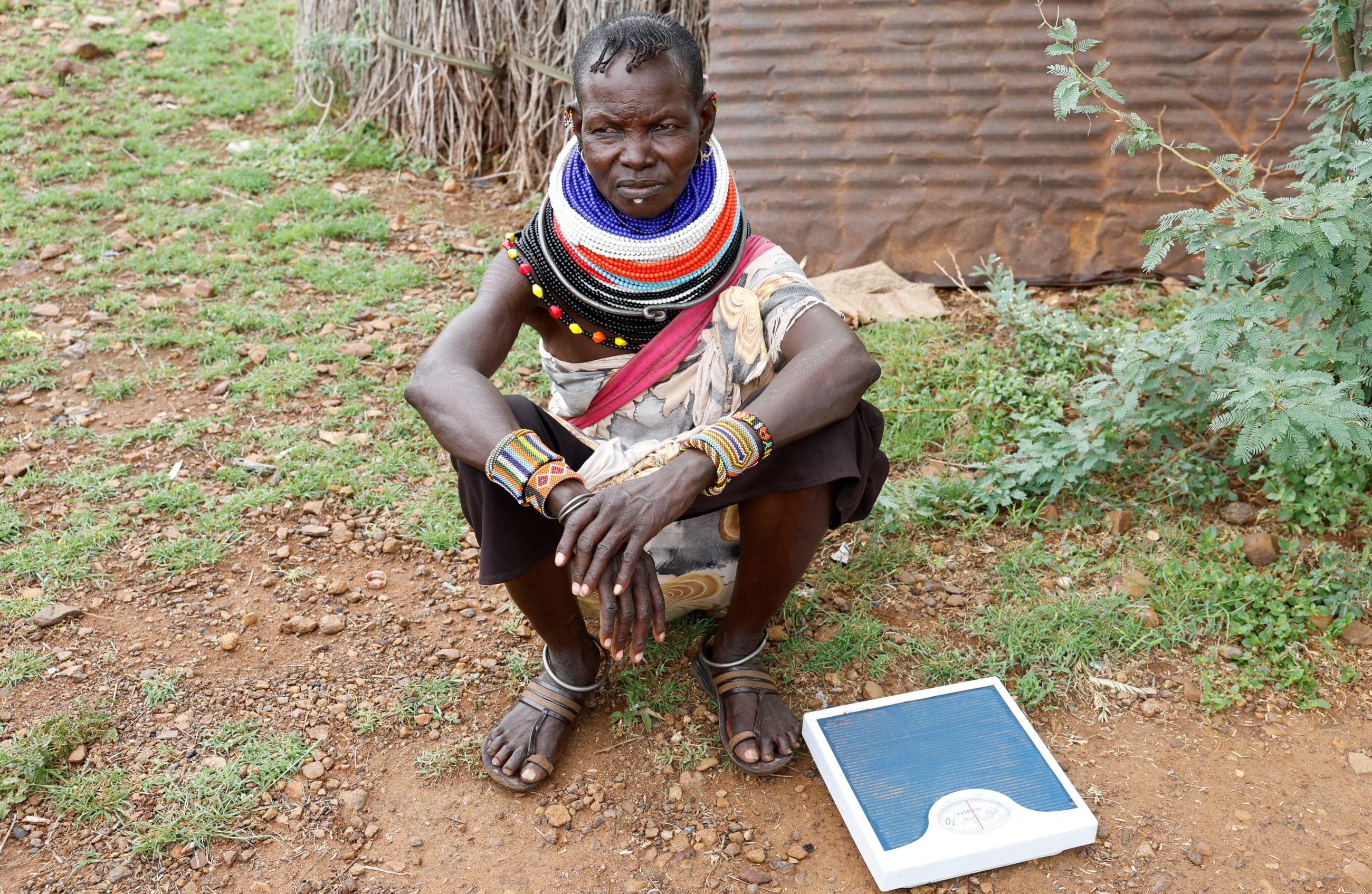 Achok Lokakach, a Turkana community health worker, sits after screening children for malnutrition in Aposta village, Turkana County, Kenya, October 30, 2025.