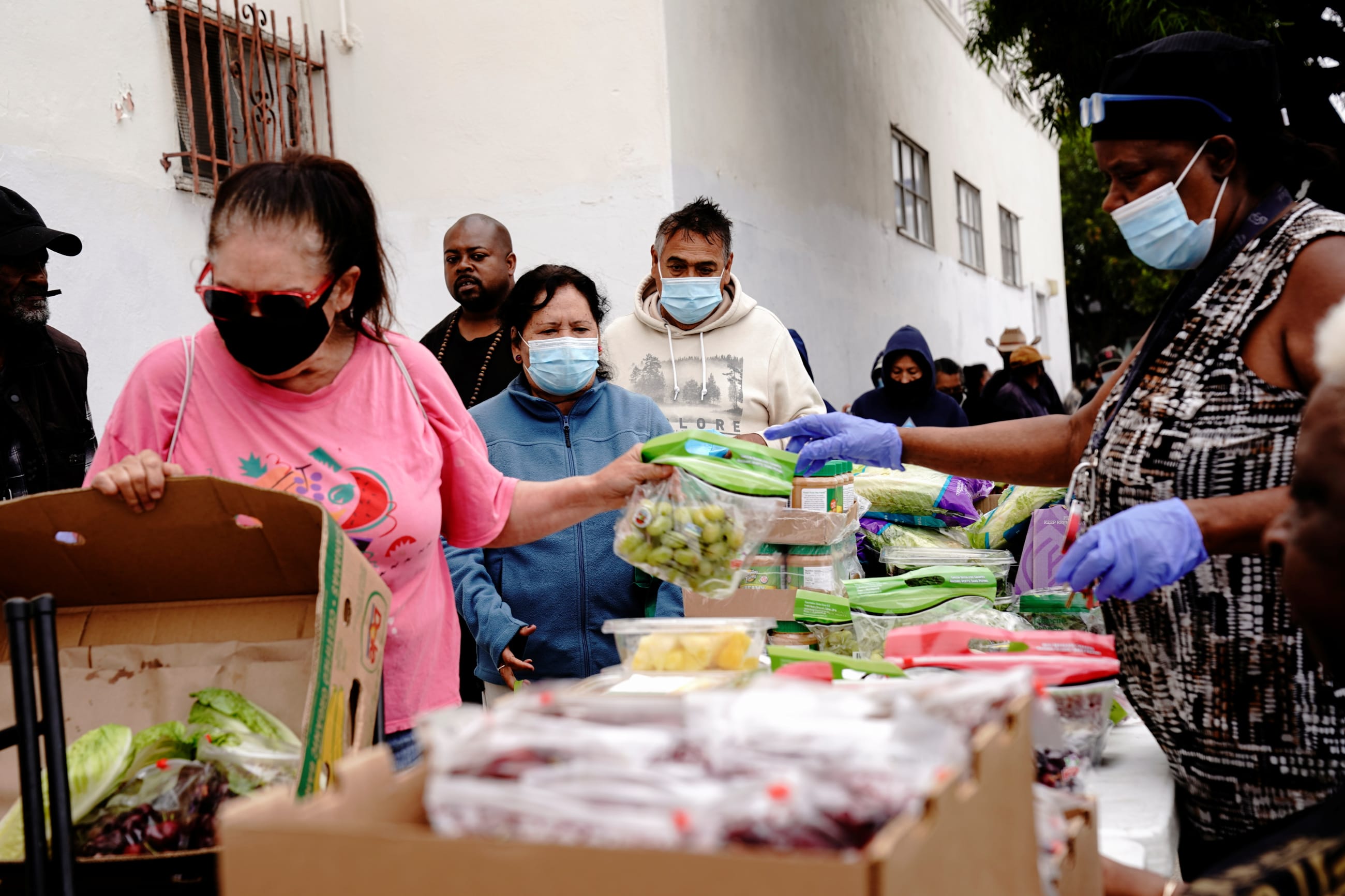 Volunteers distribute aid packages to people experiencing food insecurity at a give-away of food and baby formula held by the San Diego Original Black Panther Party for Community Empowerment, in San Diego, California, on May 25, 2022.