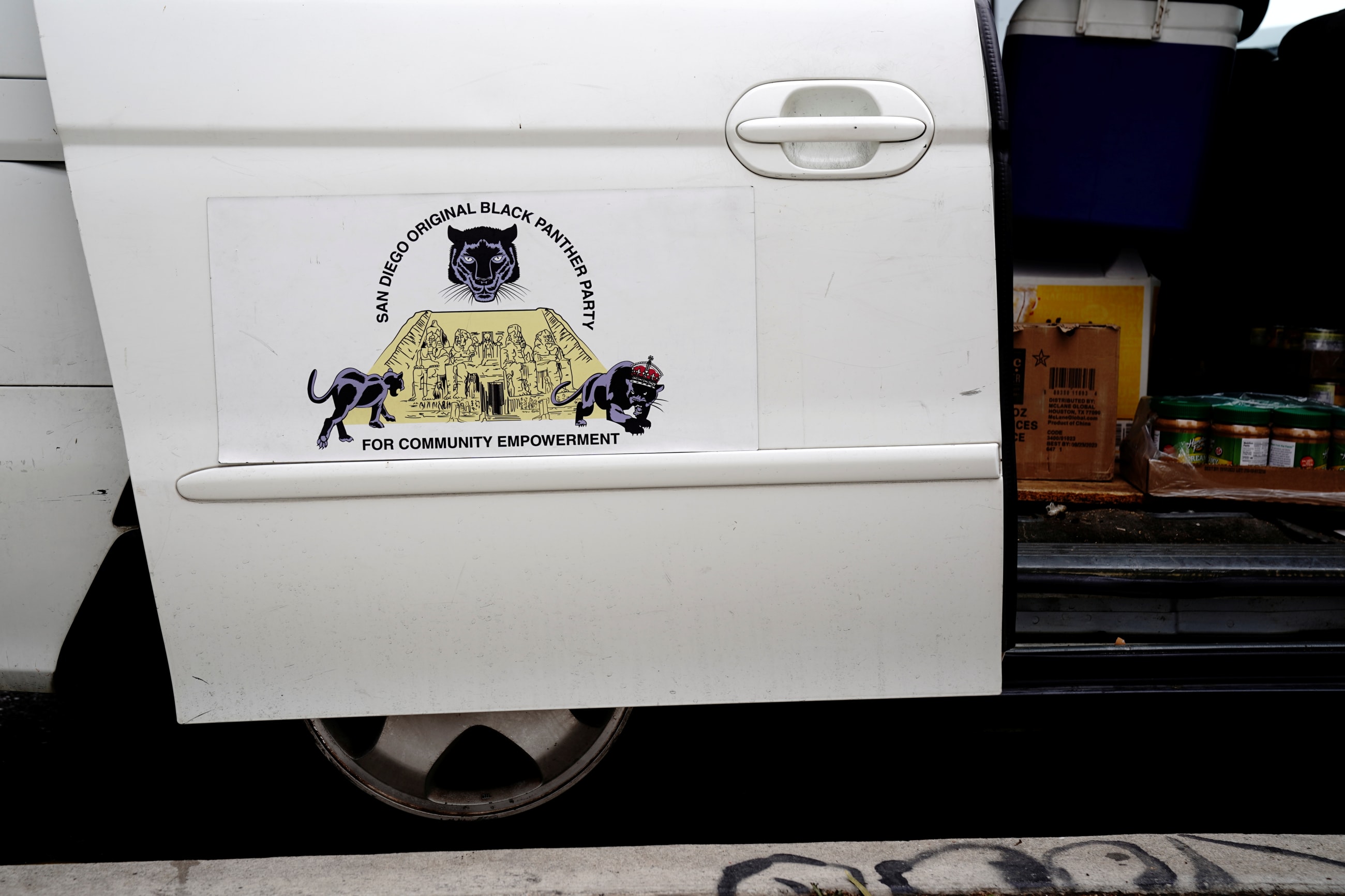 Food for distribution to people experiencing homelessness is seen inside a minivan displaying a San Diego Original Black Panther Party for Community Empowerment magnet, in San Diego, California, on May 25, 2022.