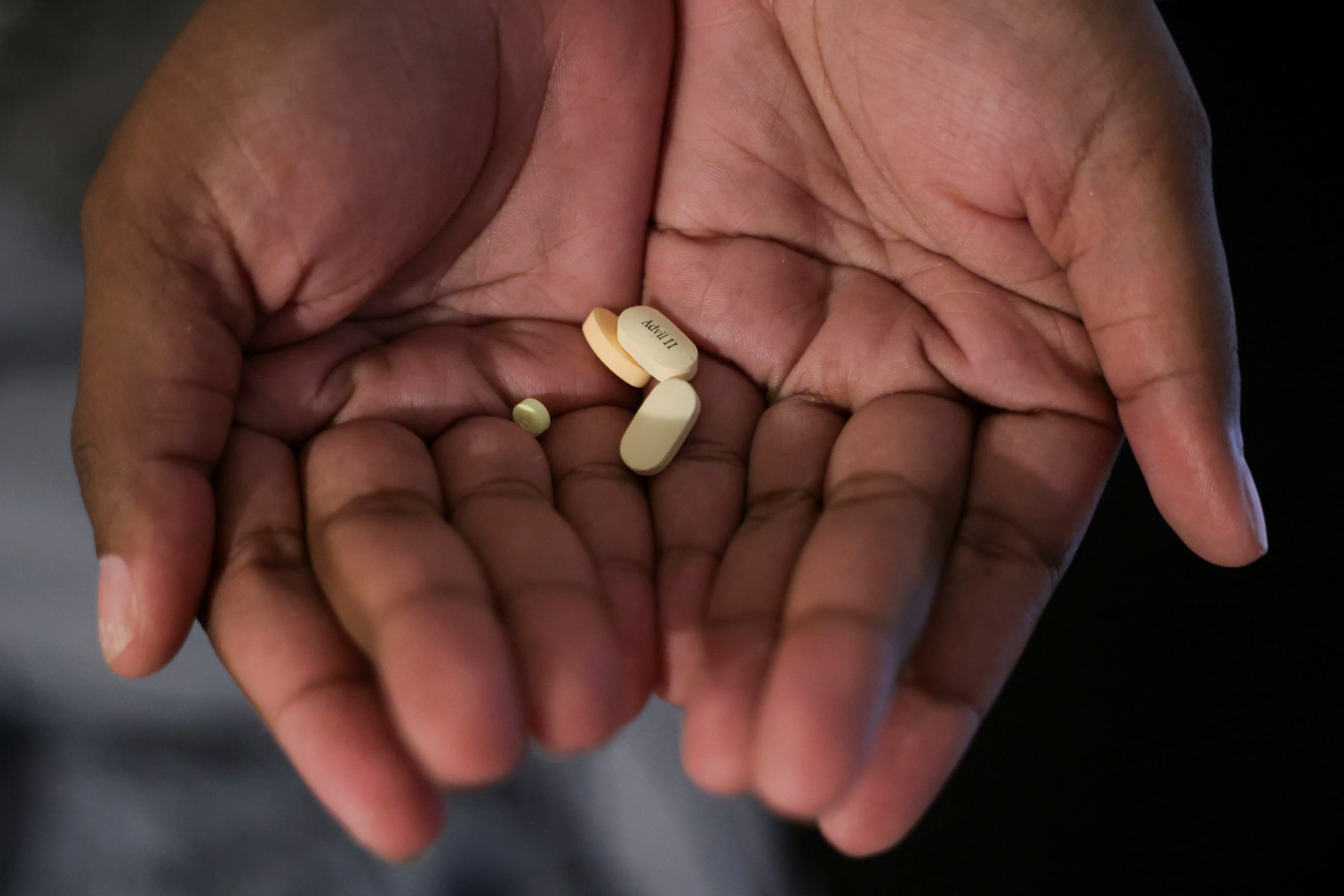 Kayla Smith Owens, who has sickle cell and advocates for awareness about the disease, holds the prescribed pills in her hands, in Chesapeake Beach, Maryland, on August 17, 2024.