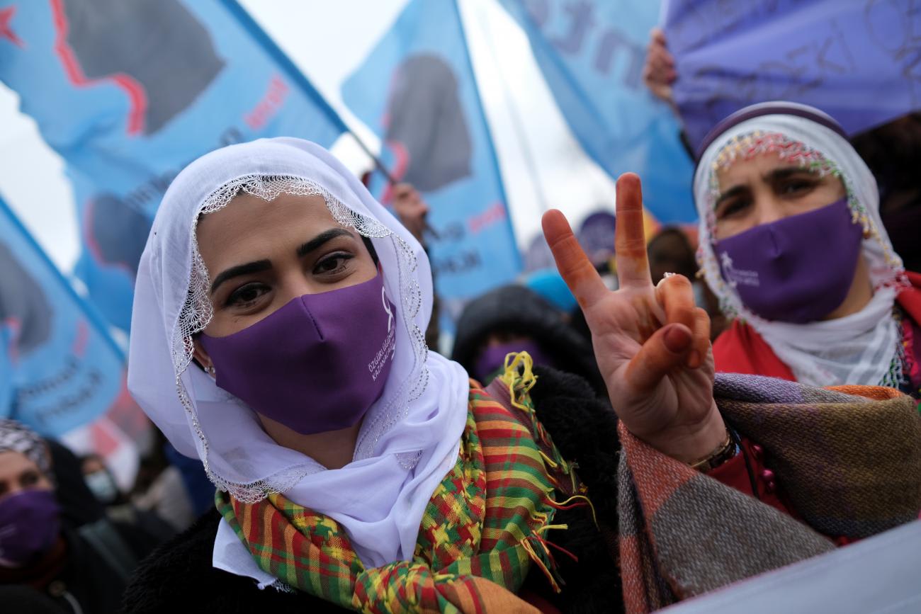 A demonstrator wearing a face mask to prevent the spread of the coronavirus disease (COVID-19) flashes the V sign during a rally ahead of the International Women's Day in Istanbul, Turkey March 6, 2021.