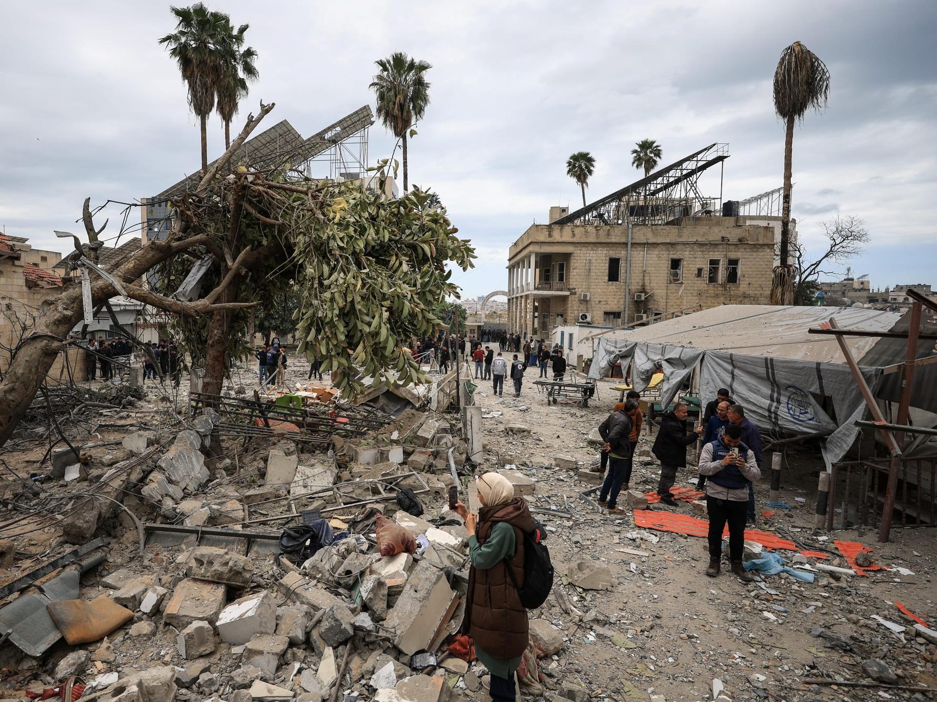 Palestinians inspect the damage after two Israeli missiles hit a building inside the Al-Ahli Arab Baptist Hospital, in the Gaza Strip, on April 13, 2025