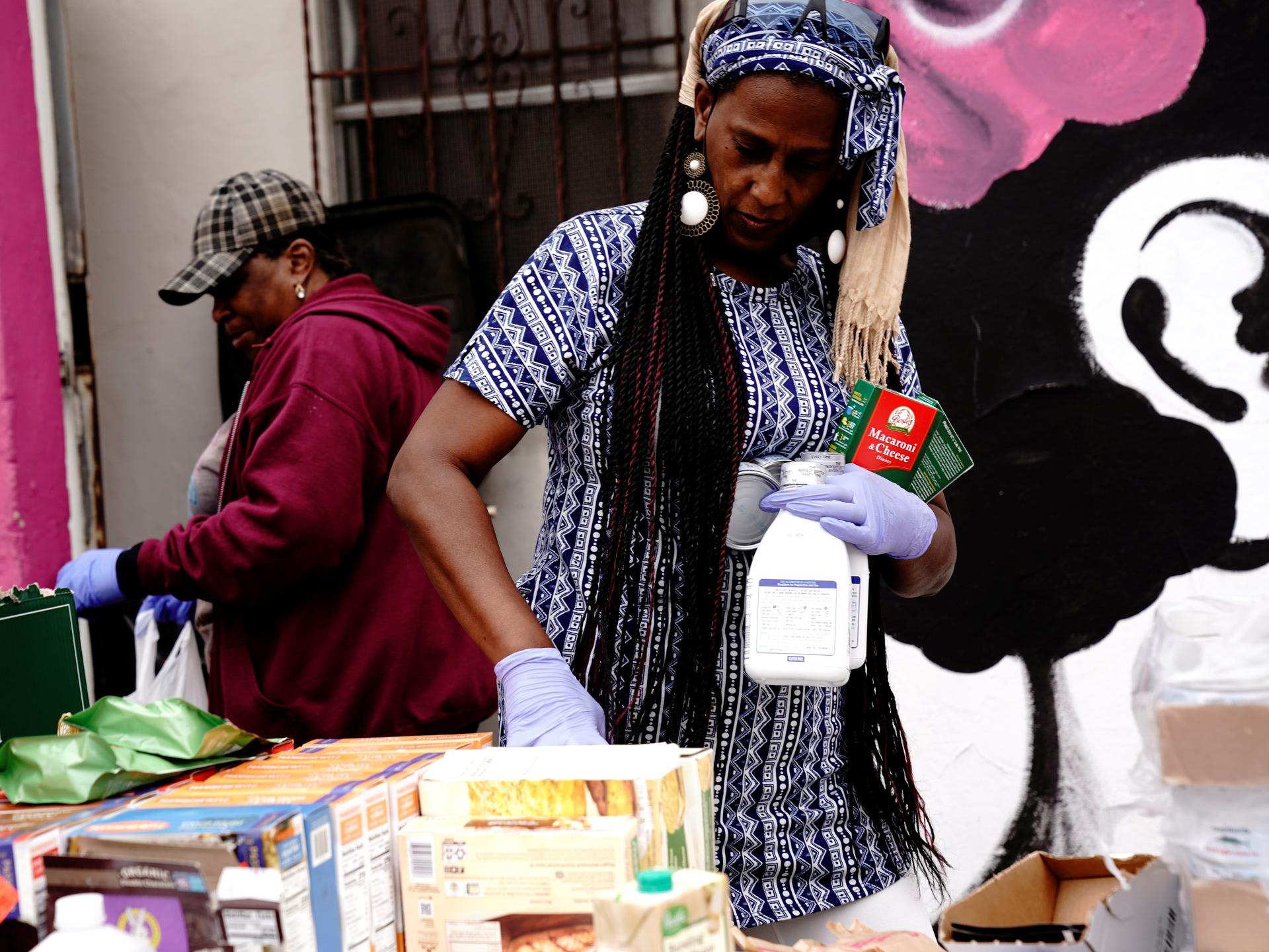 A volunteer grips bottles of Similac baby formula at a give-away of food and baby formula, held by the San Diego Original Black Panther Party for Community Empowerment, in San Diego, California, on May 25, 2022.