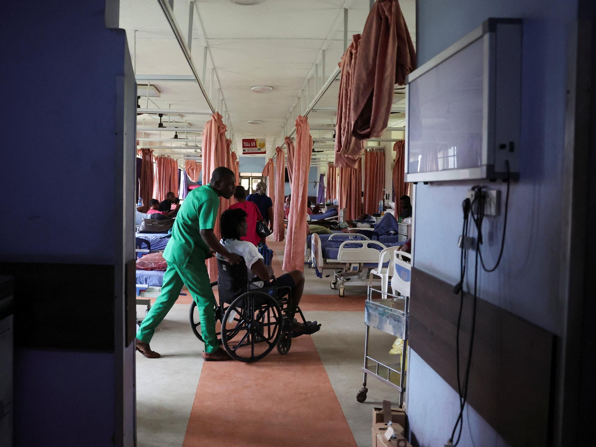 An injured patient is wheeled out of the out-patient ward of the National Orthopaedic Hospital, in Lagos, Nigeria, on July 30, 2025.