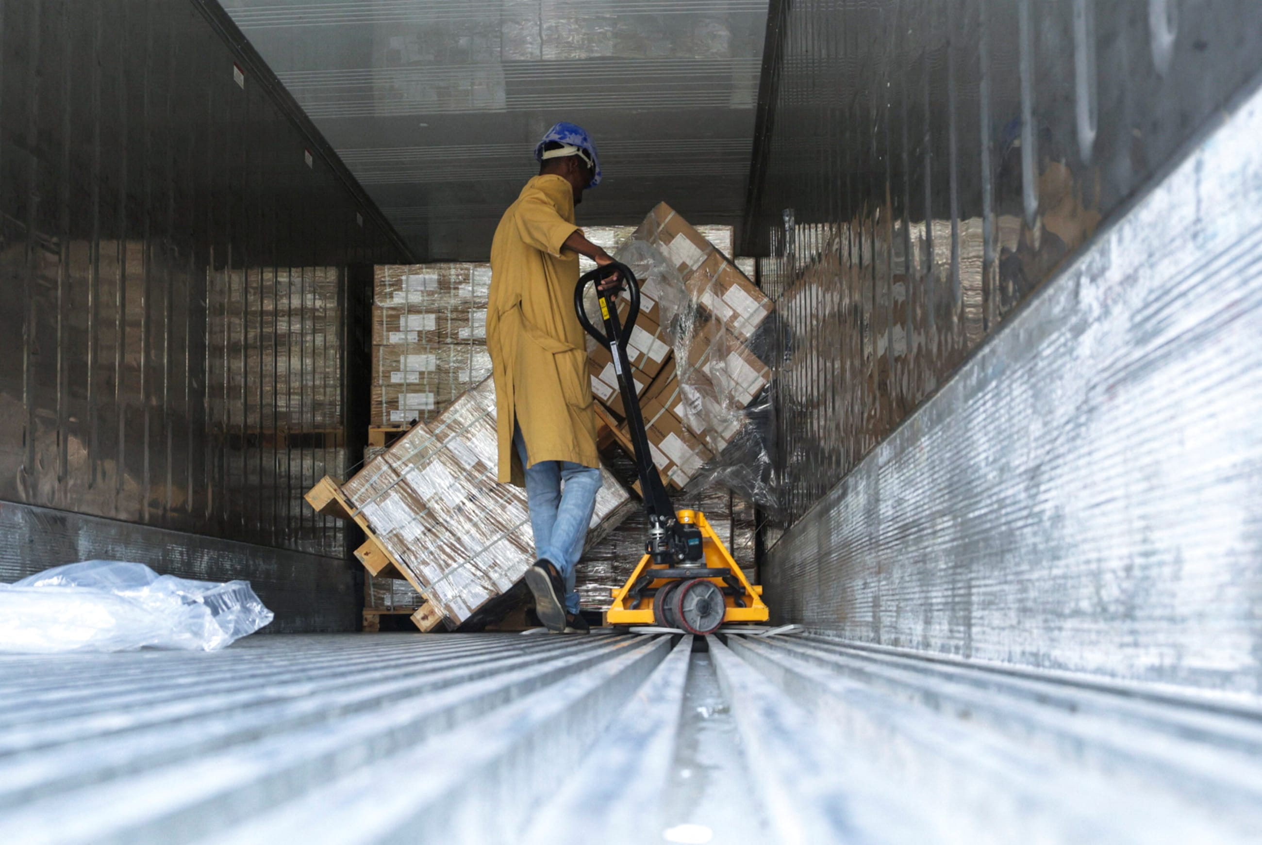 A worker unloads packets of Artesunate, an antimalarial medication, in a warehouse, in Maroua, Cameroon, on September 2, 2025.