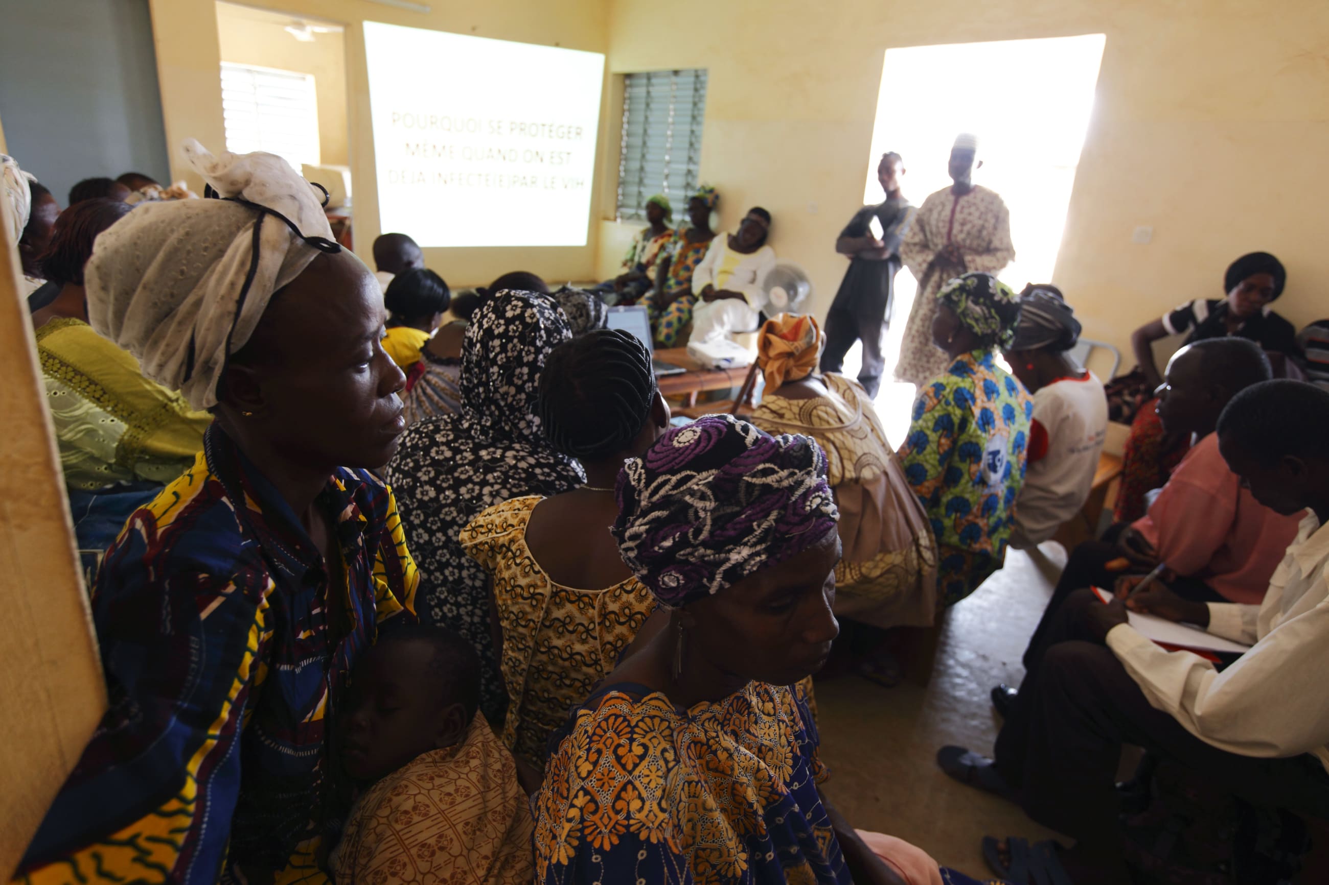 People attend a talk on sexual health and HIV prevention, in the Tanghin neighborhood of Ouagadougou, Burkina Faso, on April 13, 2013.